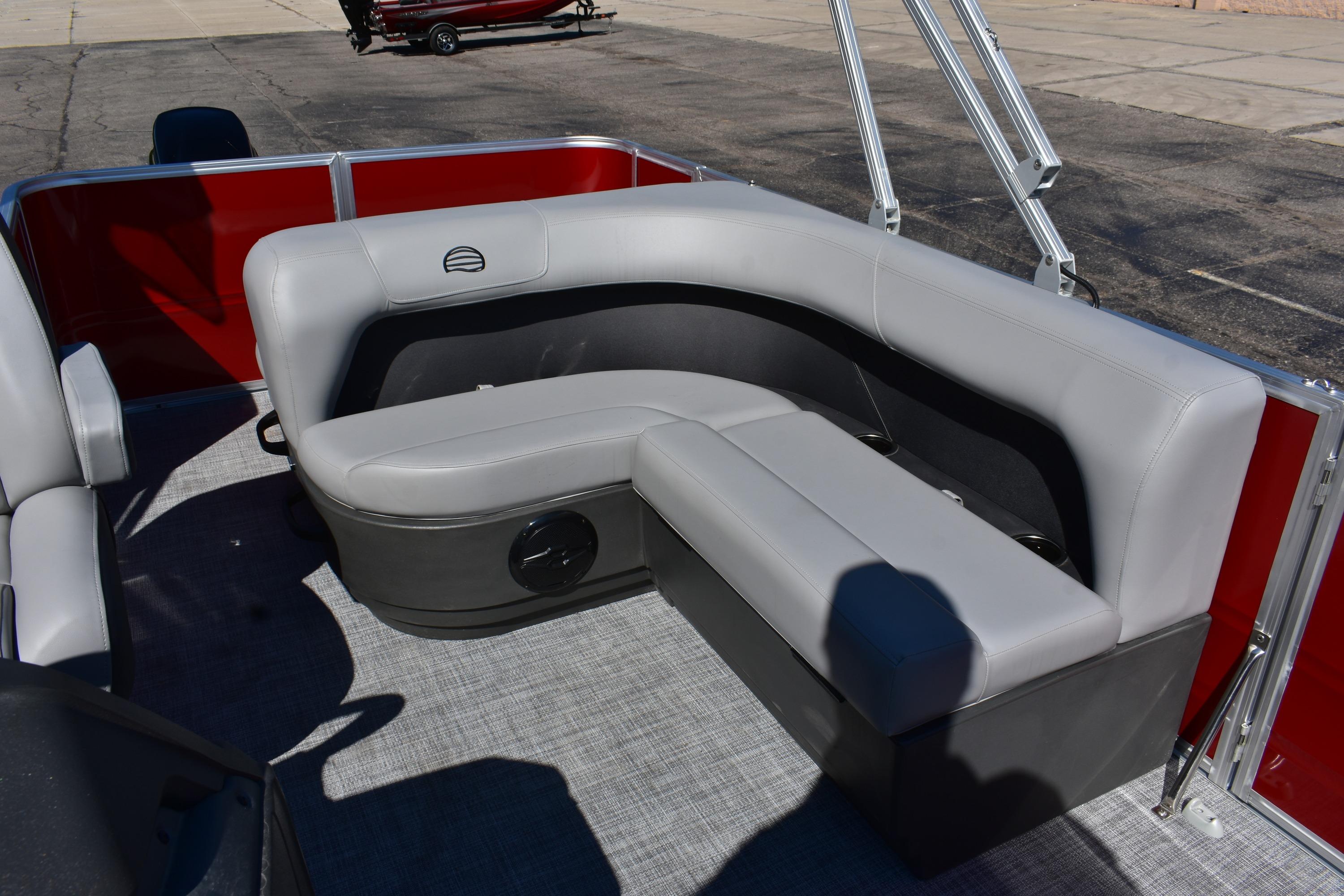 2026 Sun Tracker Party Barge 18 DLX with gray seating and red accents on deck.