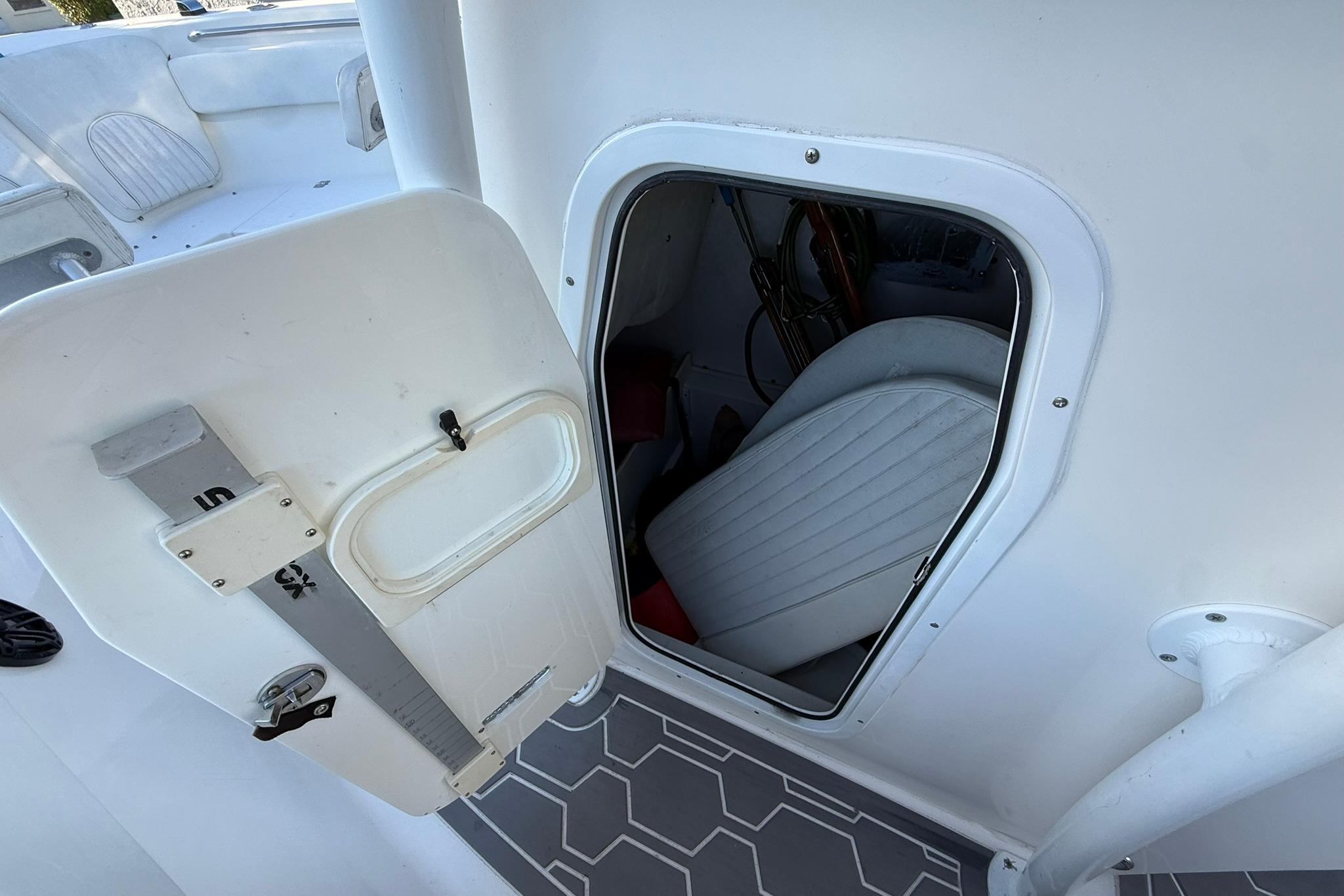 2014 Sea Fox 256 Commander boat interior storage compartment with open door.