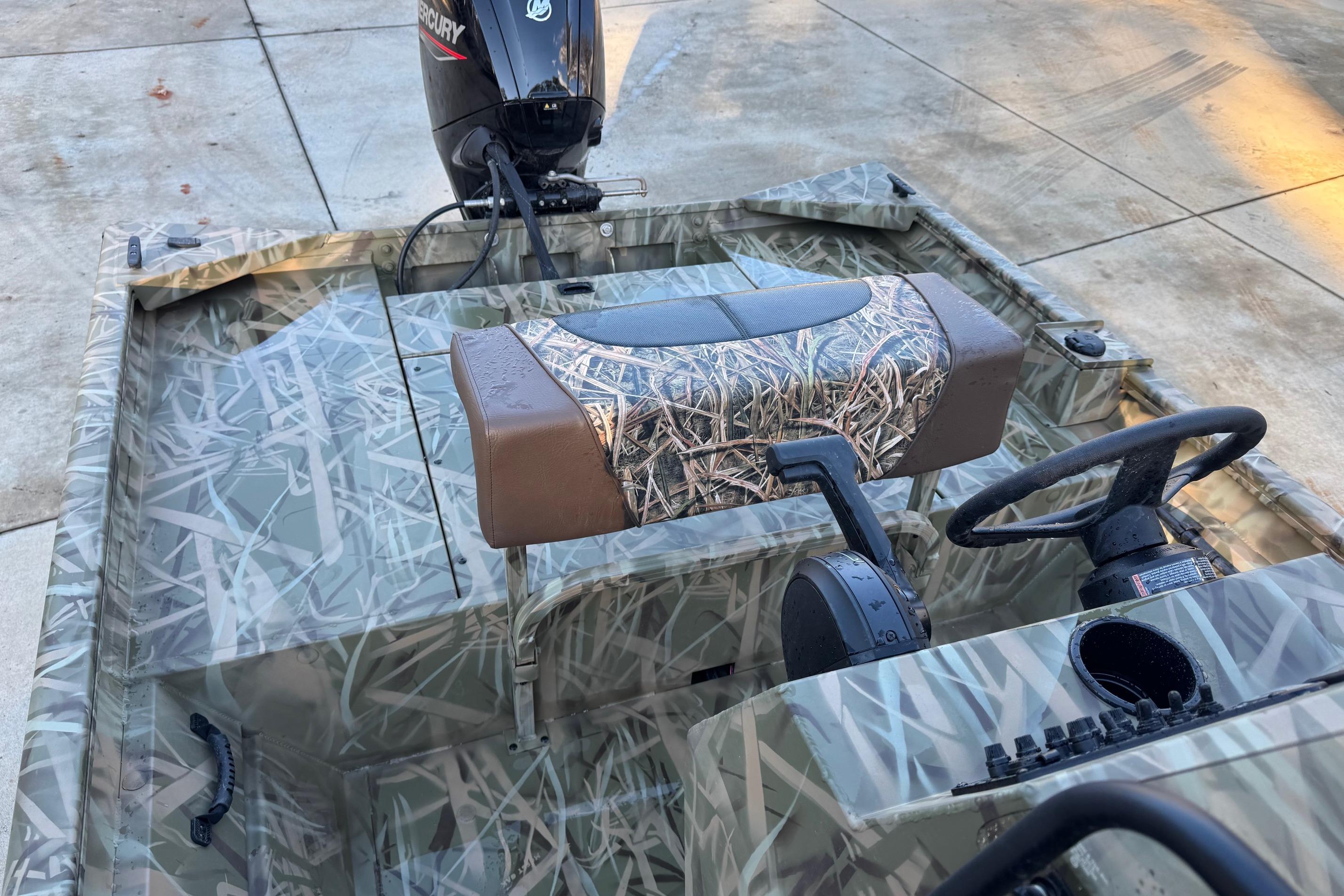 2026 Crestliner 1860 Retriever CC boat with camouflage design and Mercury outboard motor.