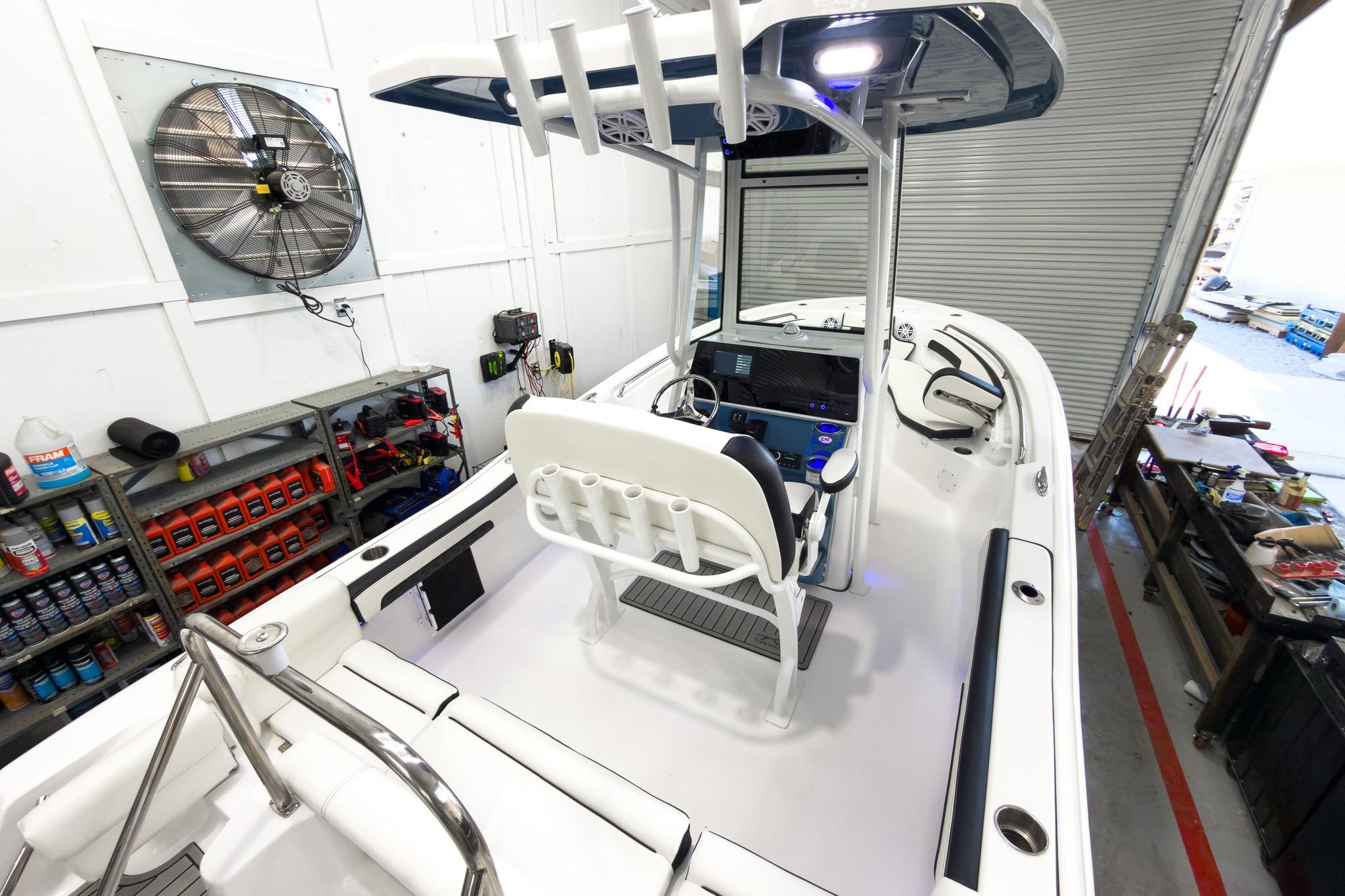 The image shows a modern boat with a central console and a T-top roof.