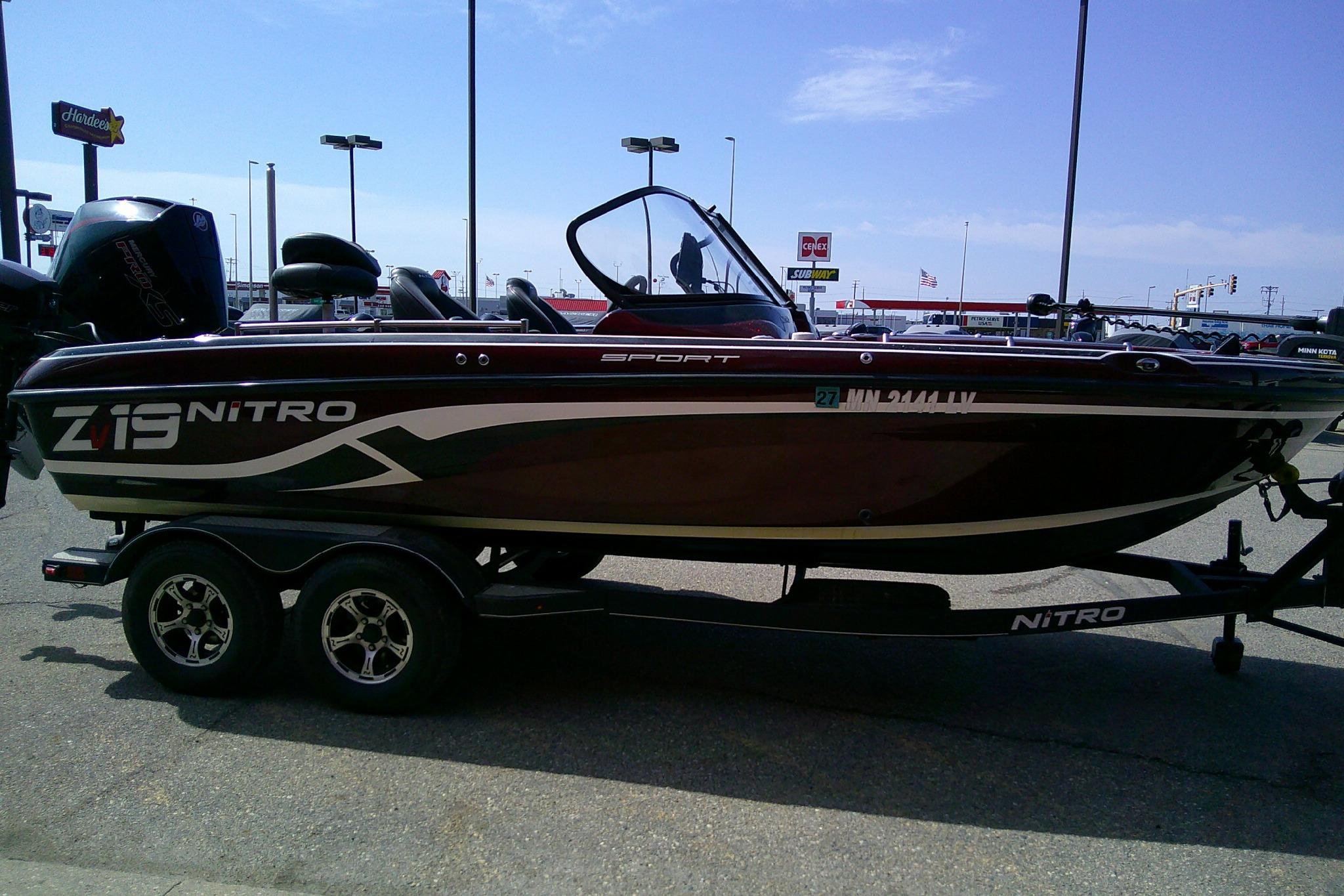2019 Nitro ZV19 Sport boat on trailer in parking lot, side view.