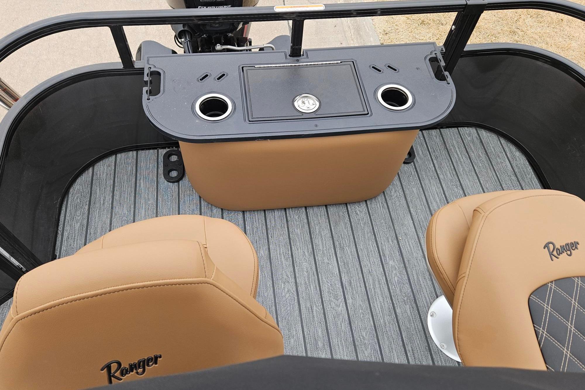 2026 Ranger 220F boat interior with tan seats and a central console.