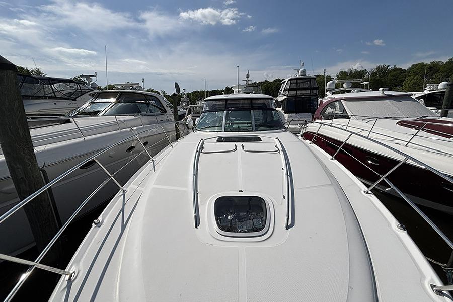 2006 Sea Ray 44 Sundancer yacht docked among other boats under a clear sky.