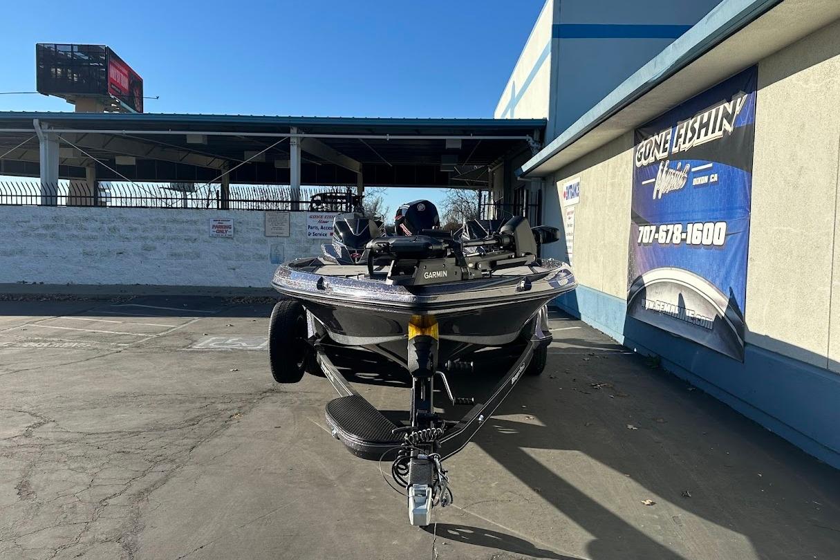 2026 Ranger Z521R Garmin Cup-Equipped boat parked outside a fishing store.