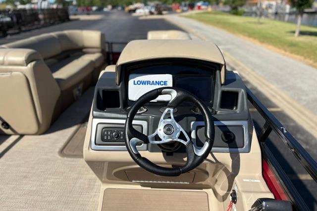 ```json "2025 Regency 250 DL3 boat dashboard with steering wheel and Lowrance display." ```