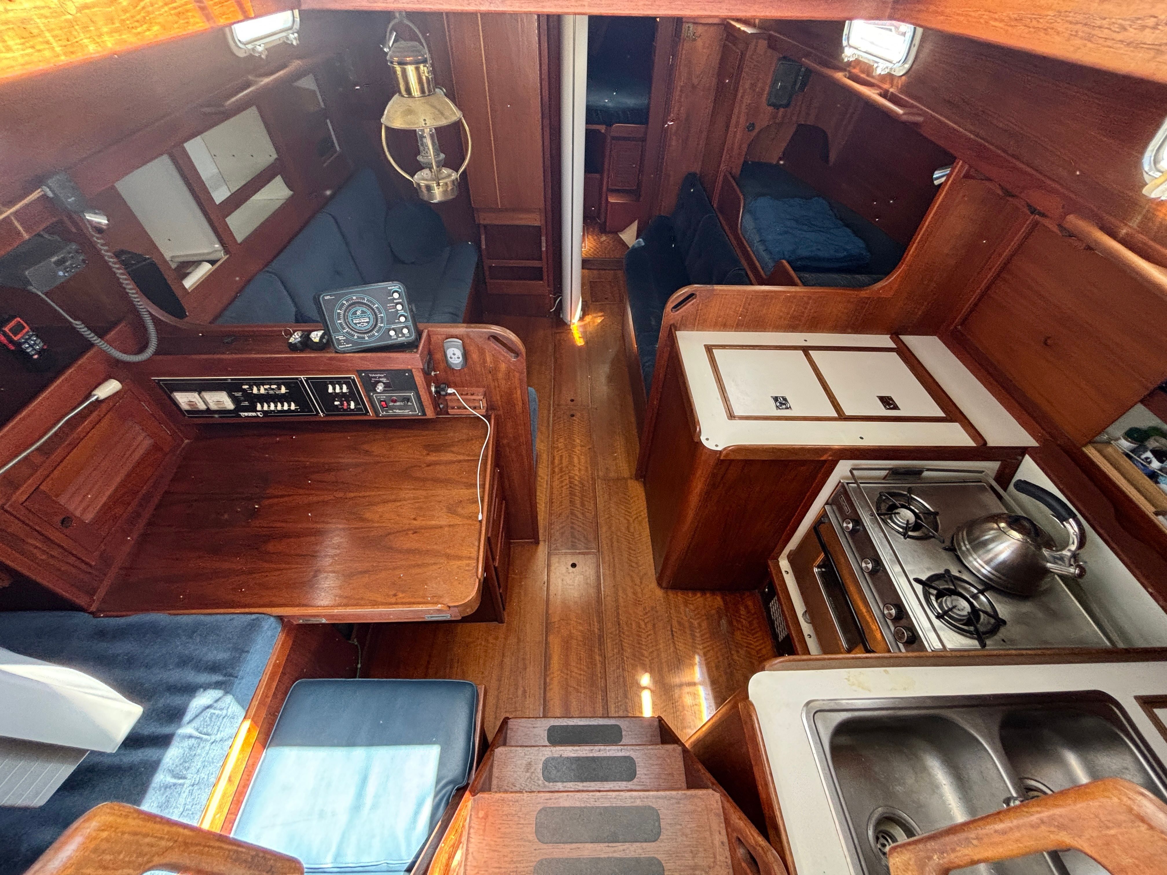 Interior of a 1979 Tartan 37 sailboat with wood finish and galley.
