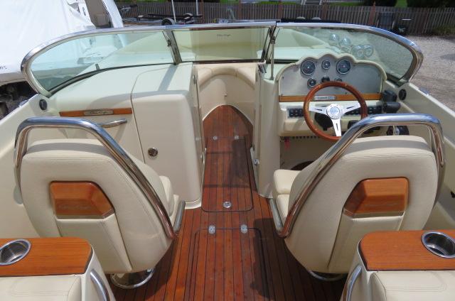 2021 Chris-Craft Launch 27 interior with wood accents and leather seating.