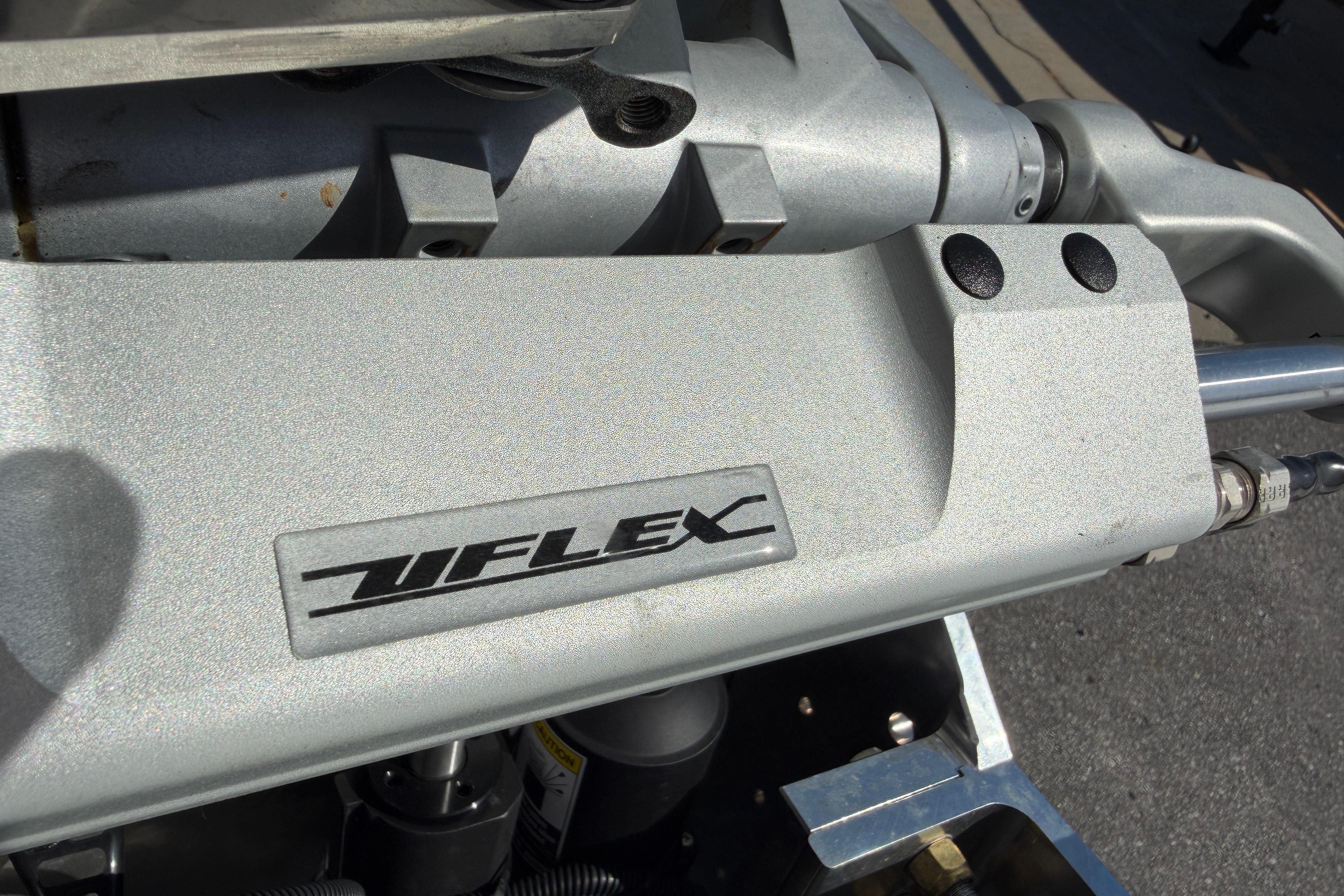 Close-up of Skuta 24 Cat 2026 engine component with Uflex branding.