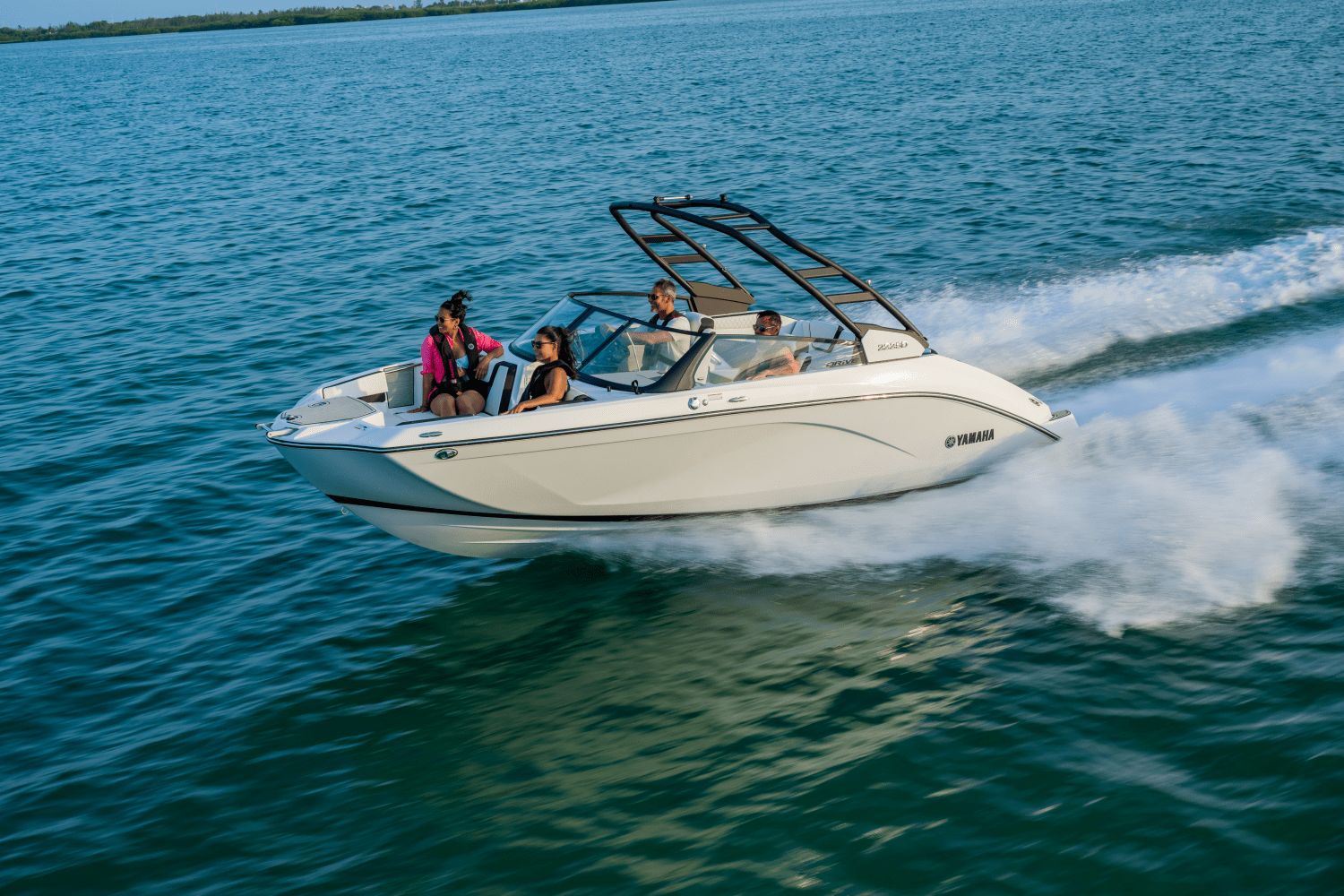The 2026 Yamaha 222SD glides over the water with four people on board.