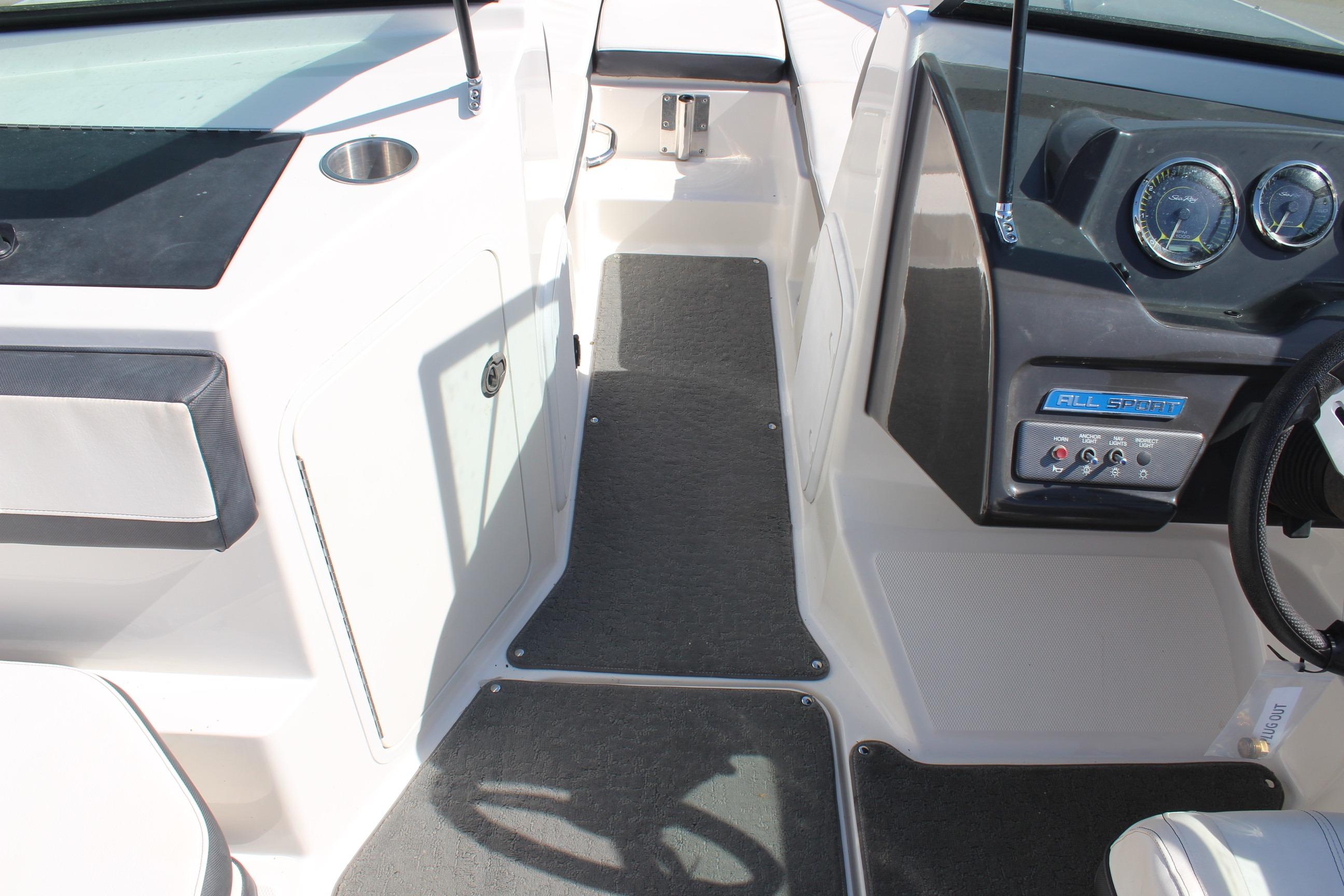 Interior view of a 2015 Sea Ray 19 SPX OB boat, featuring dashboard and seating area.