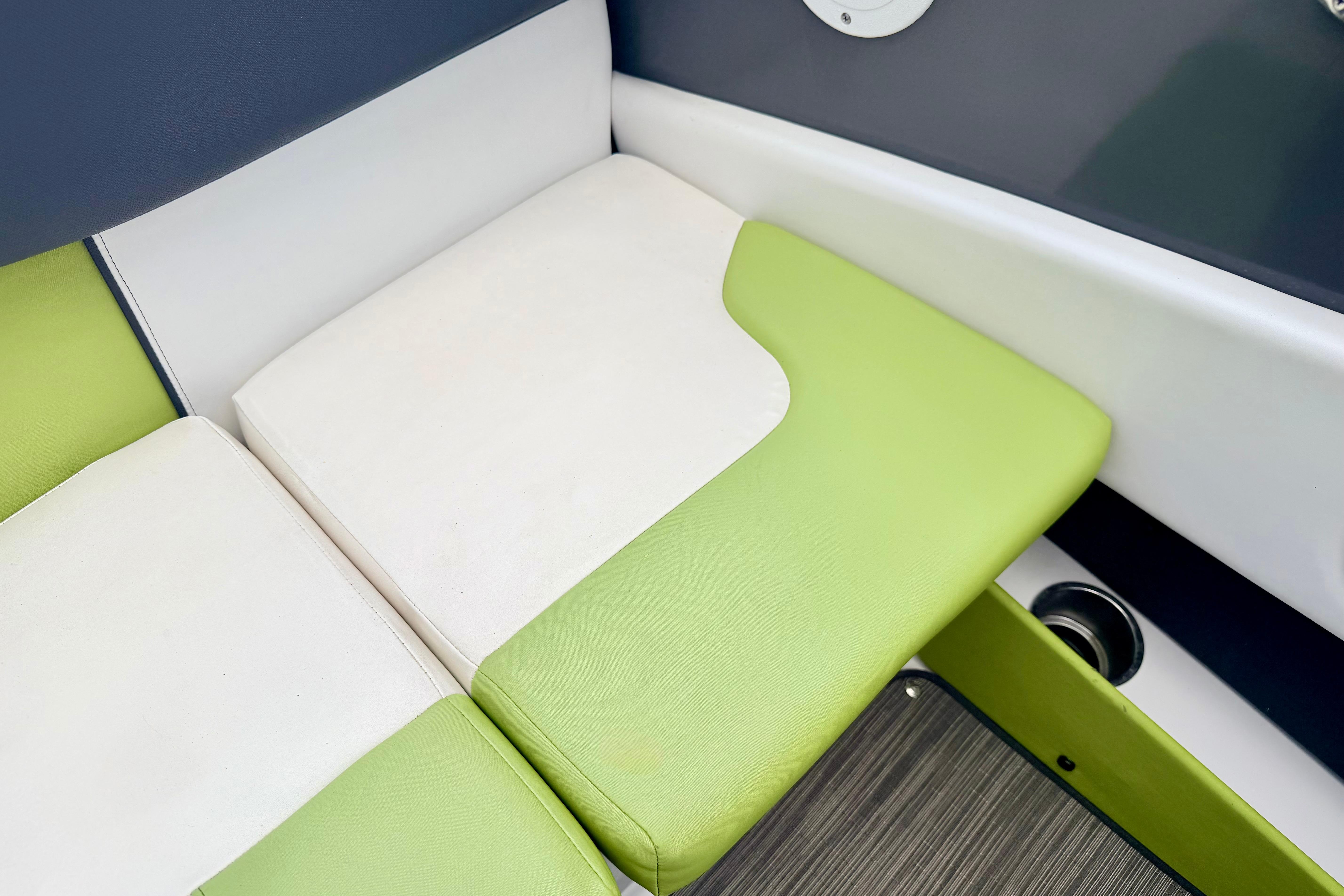 Green and white seating on 2018 Glastron GT 185 boat interior.