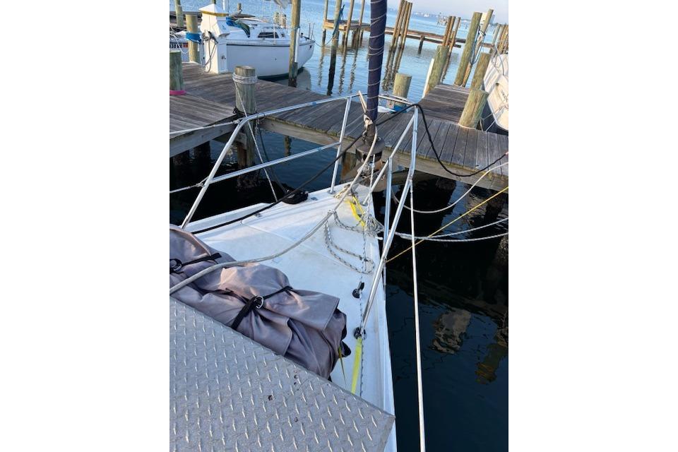 1986 Catalina 36 sailboat docked at marina with ropes and equipment visible.