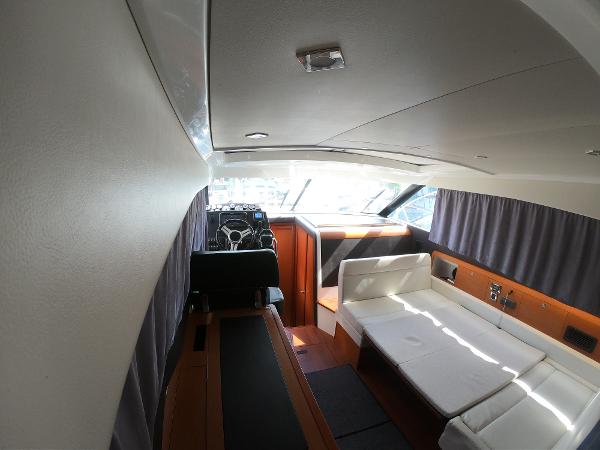Interior of 2017 Jeanneau NC 11 yacht with helm and seating area.