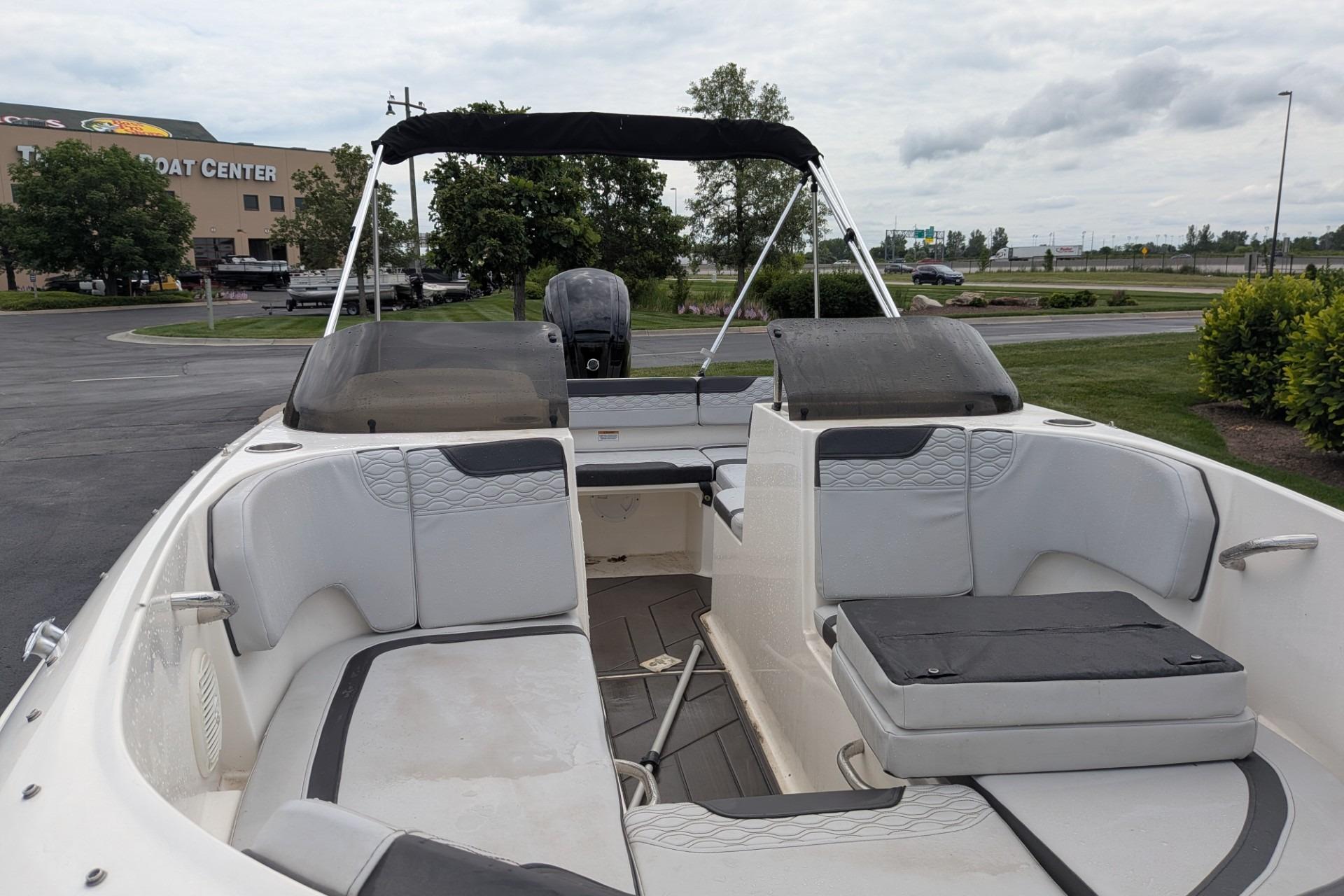 2023 Bayliner Element M17 boat interior with seating, parked near a boat center.
