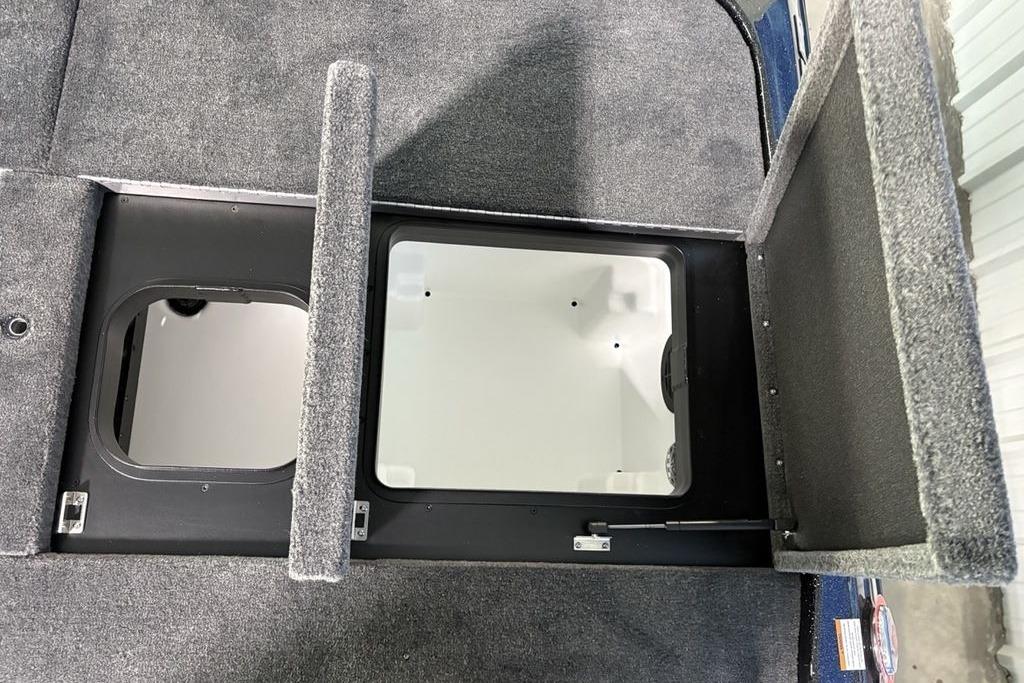2026 Skeeter ZXE21 boat storage compartments with open lids, showcasing interior space.