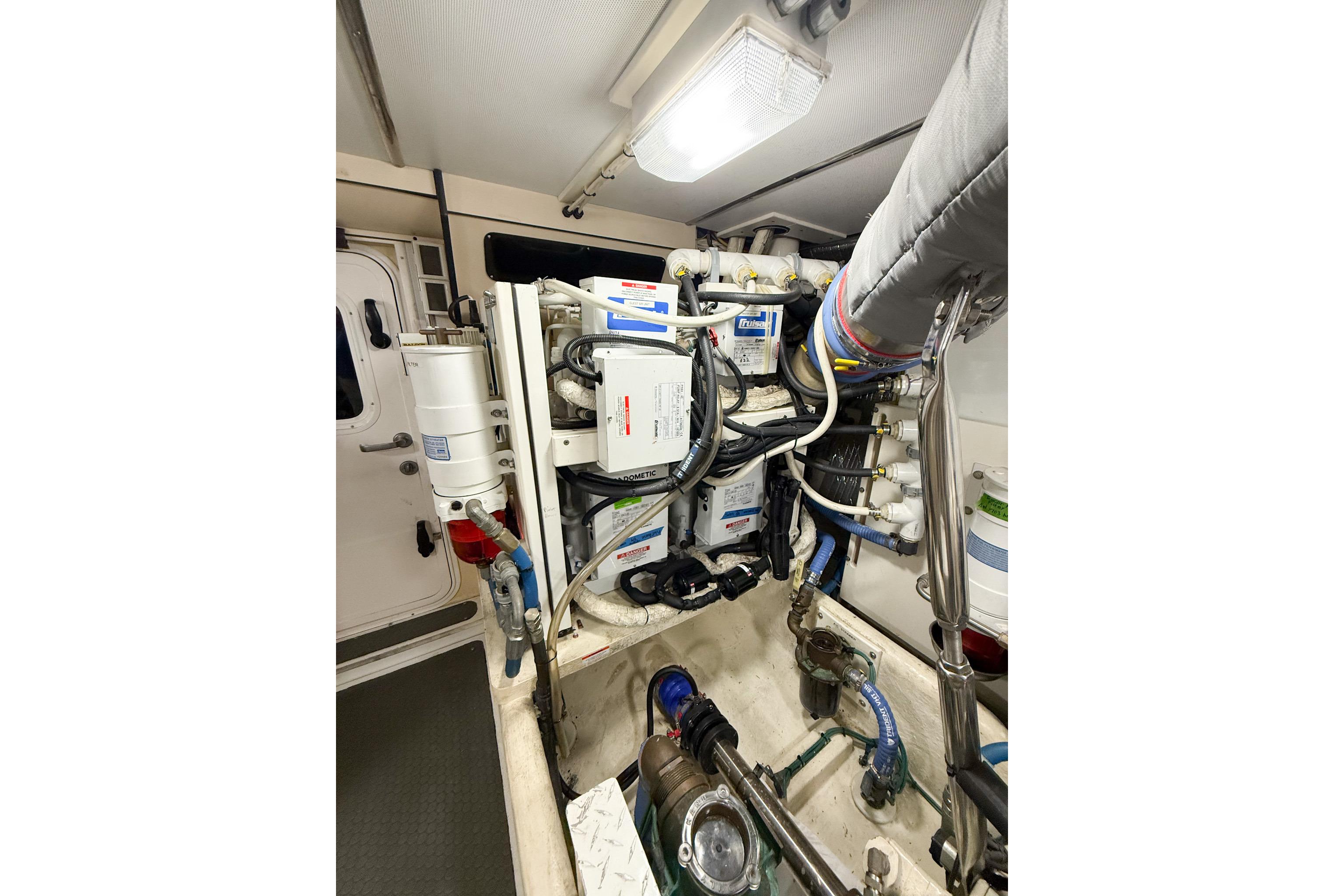 Engine room of 2007 Nordic Tug 54, showcasing complex machinery and piping.