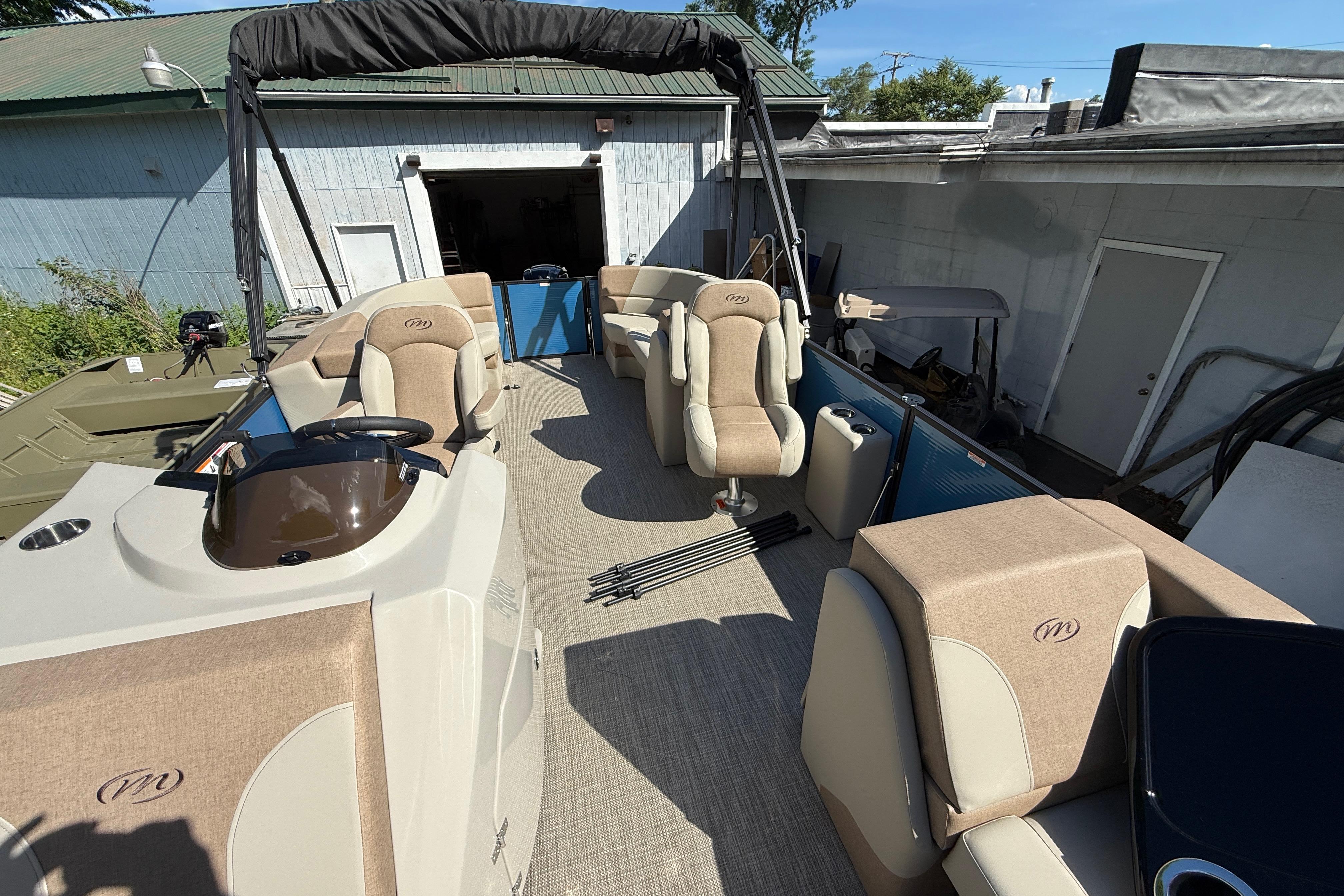 2027 Manitou Aurora RF 23 pontoon boat with beige seating and modern design.
