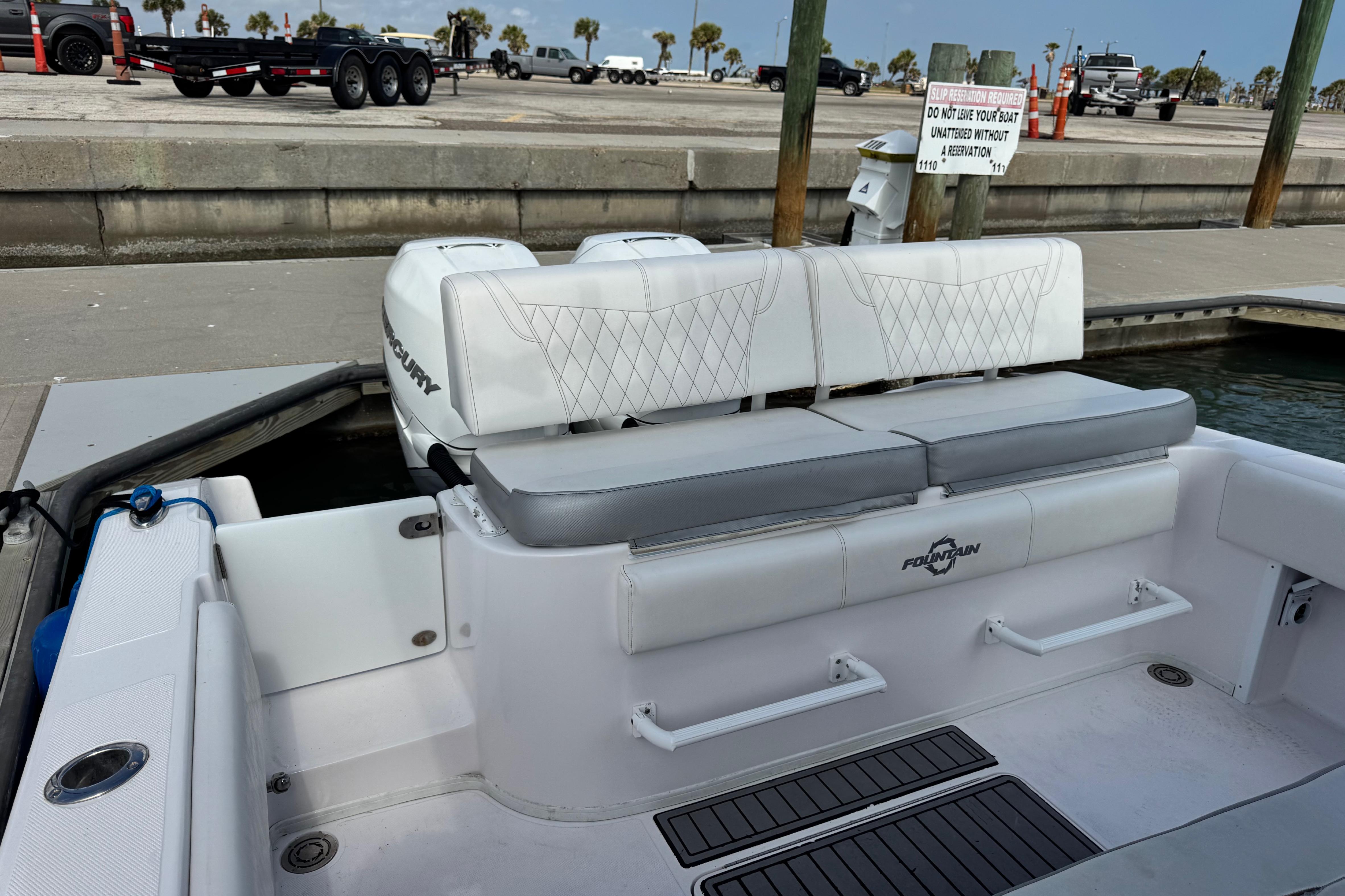 2018 Fountain 34 Center Console boat interior with seating and dock view.
