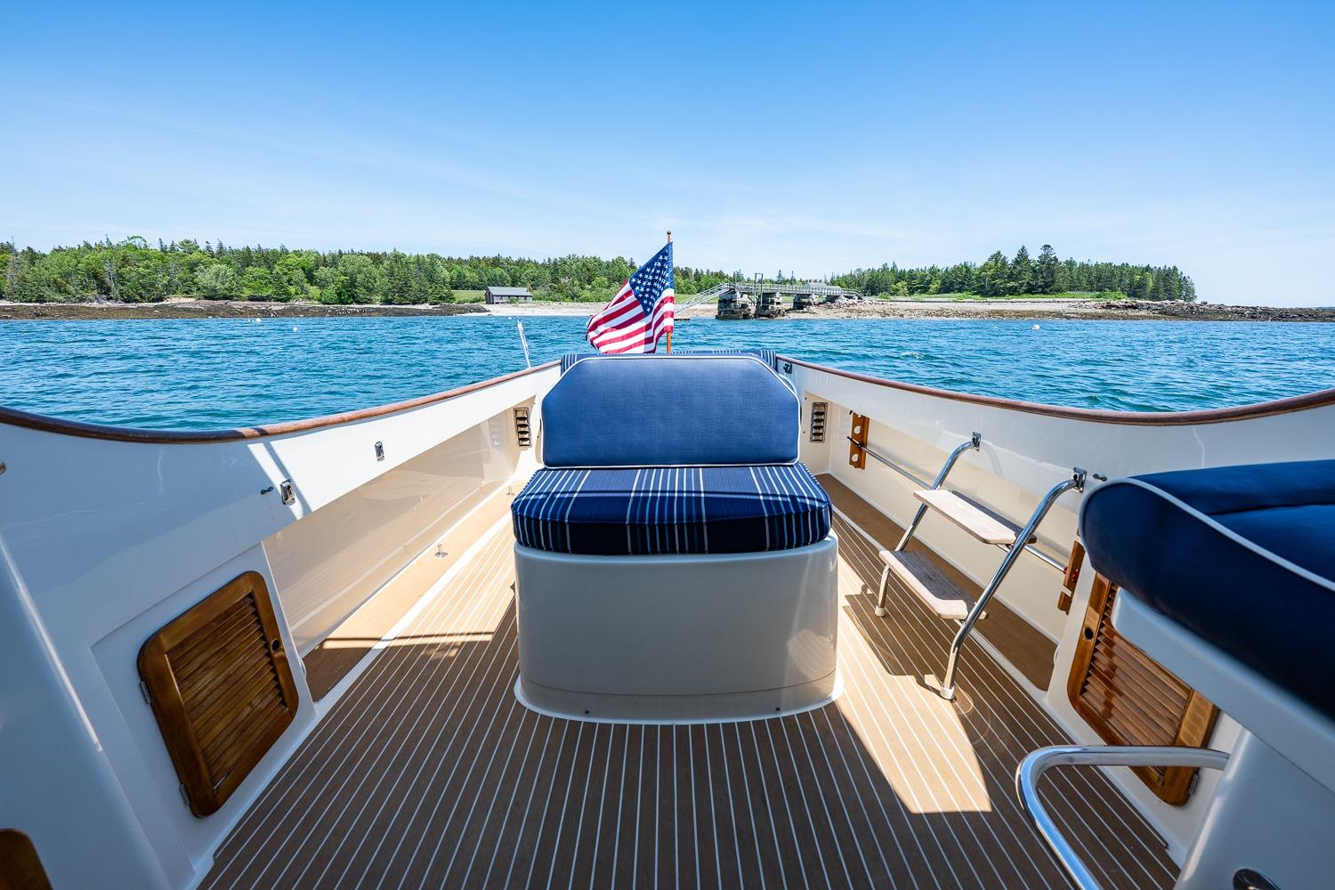 Hinckley Picnic Boat 36 Classic, 2001, with American flag, cruising on serene waters.