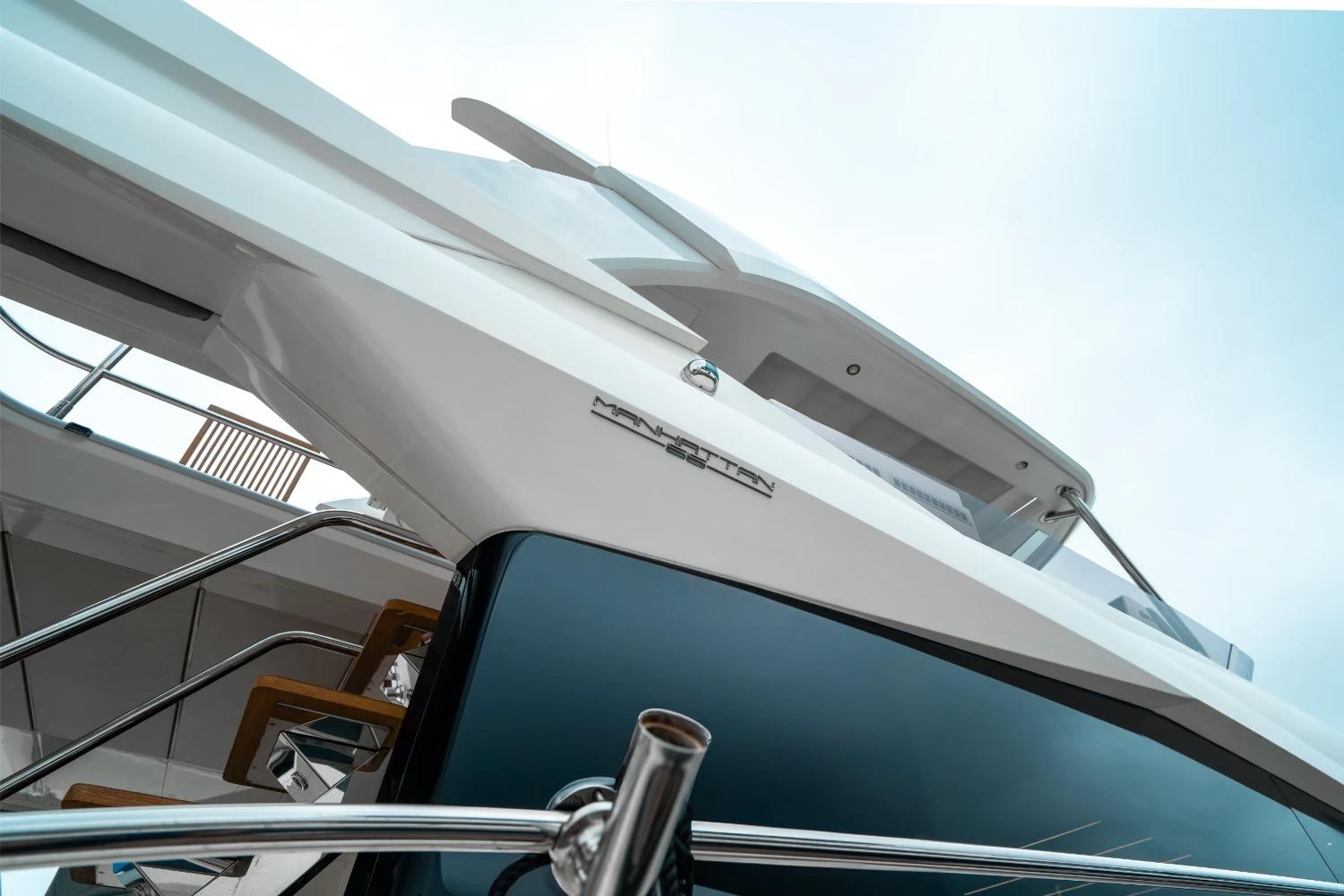 2018 Sunseeker Manhattan 66 yacht, sleek design, viewed from below against a clear sky.