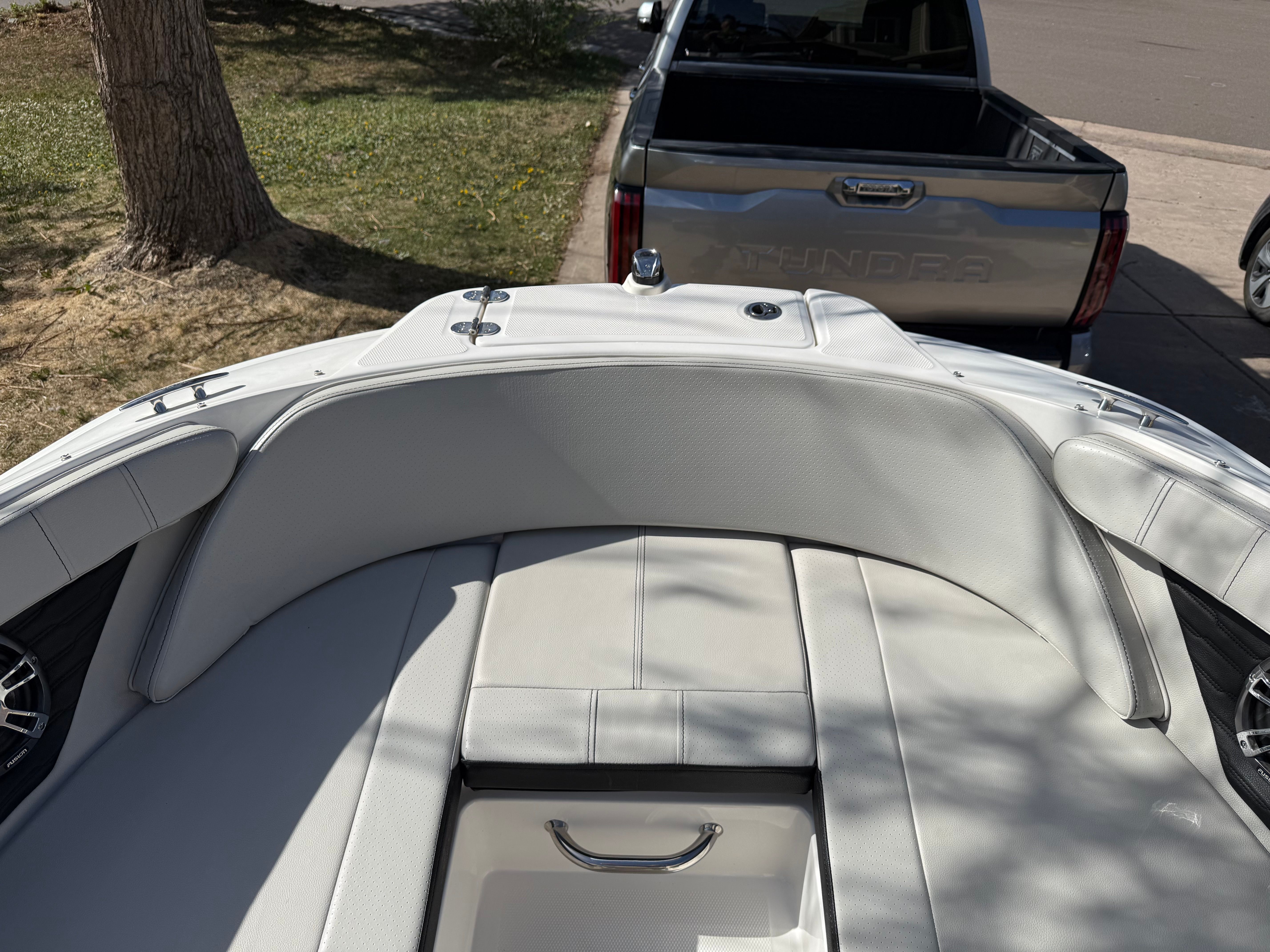 Interior of a 2022 Sea Ray SPX 210 boat with white upholstery.