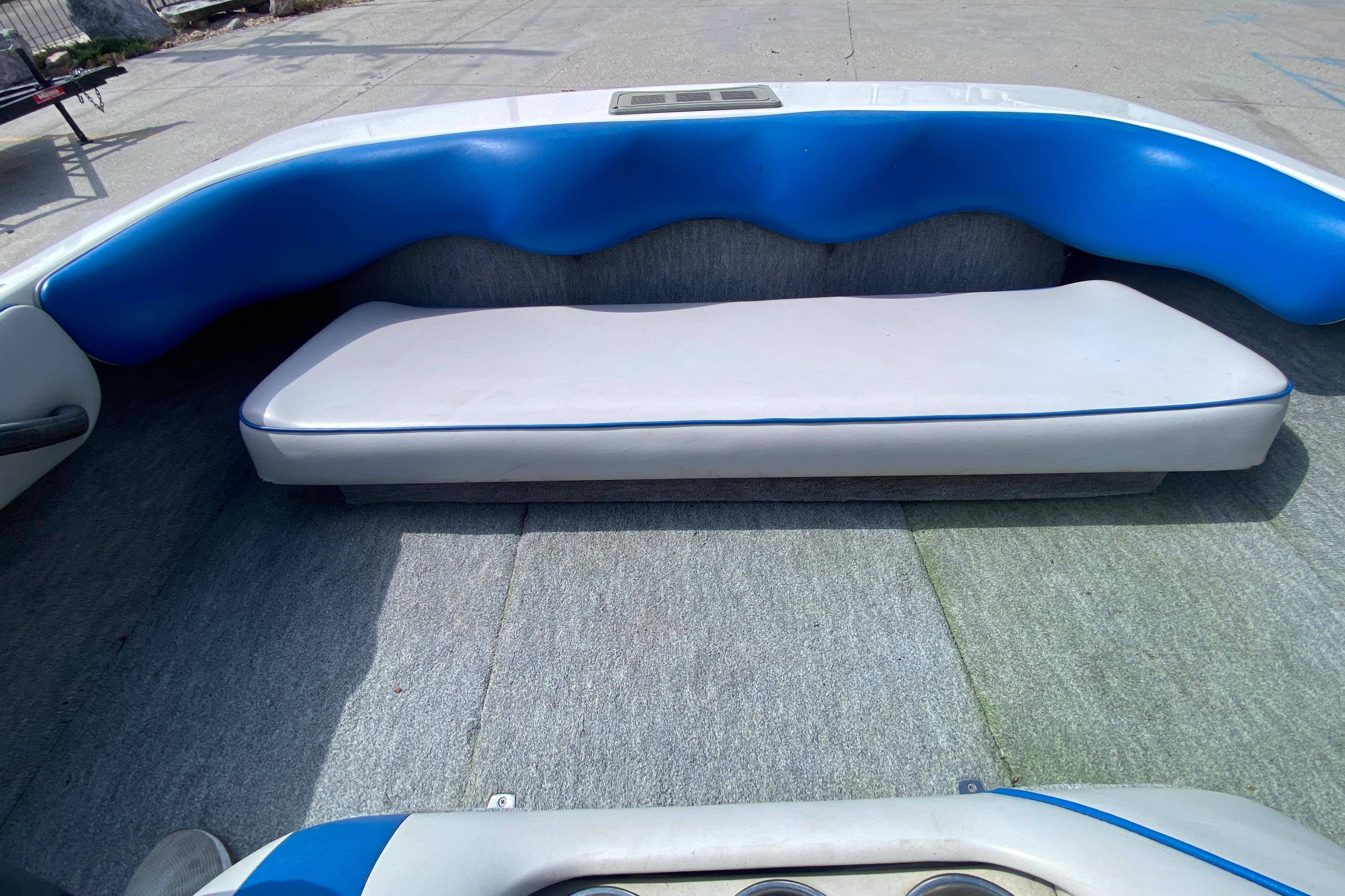 Interior of a 1997 Malibu Tantrum boat with blue and white seating.