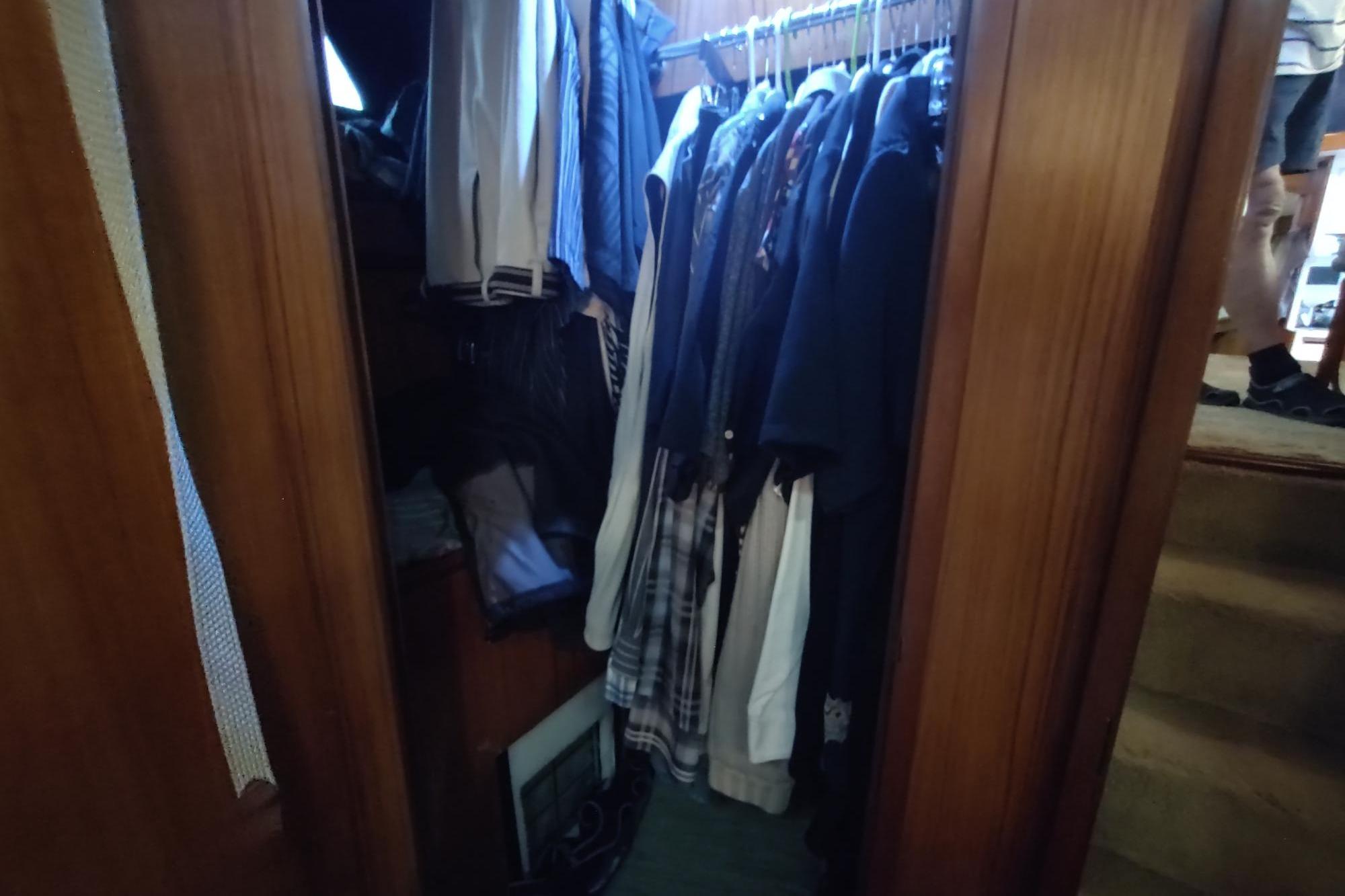 Closet with hanging clothes inside 1989 Hyatt Double Cabin Motoryacht.