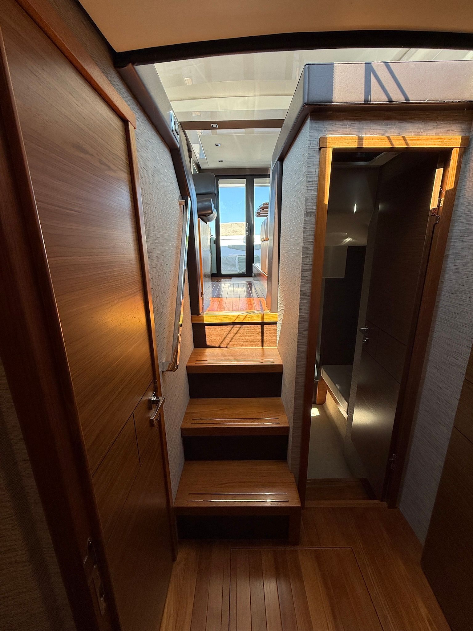 Interior of a 2017 Tiara Yachts C44 Coupe with wooden floors and stairs.