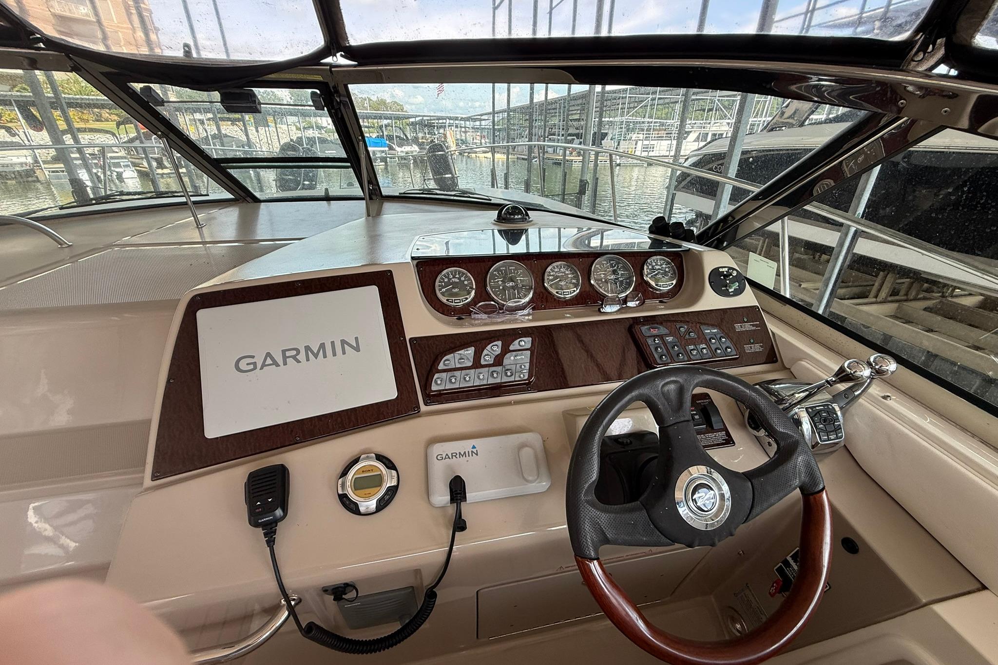 2009 Sea Ray 350 Sundancer helm with Garmin navigation system and classic wood finish.