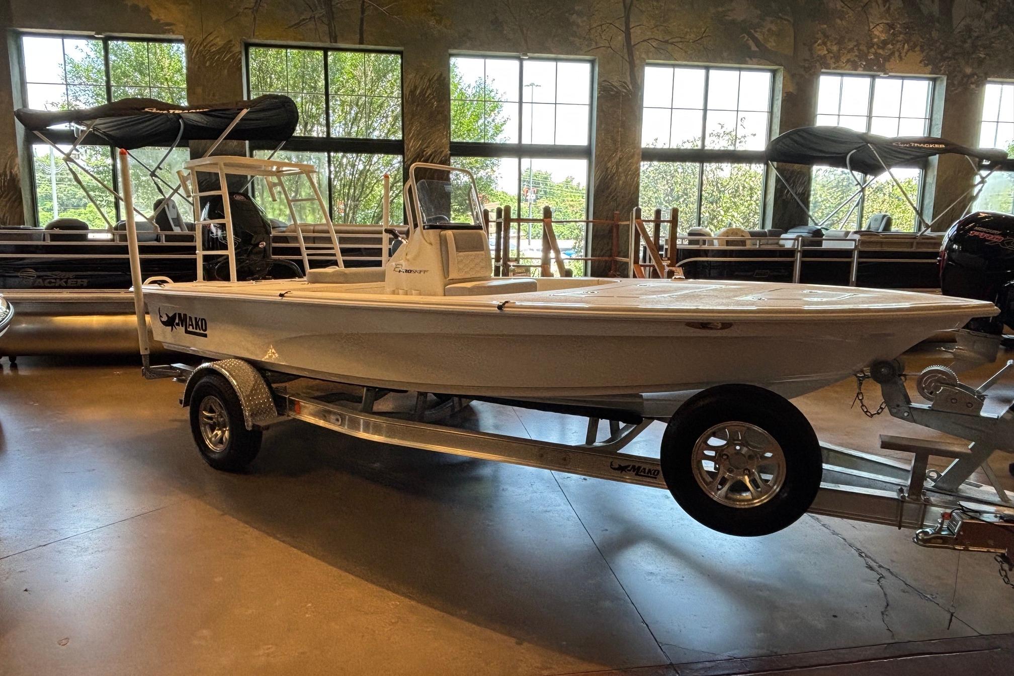 2026 Mako 18 Pro Skiff boat displayed indoors on a trailer.