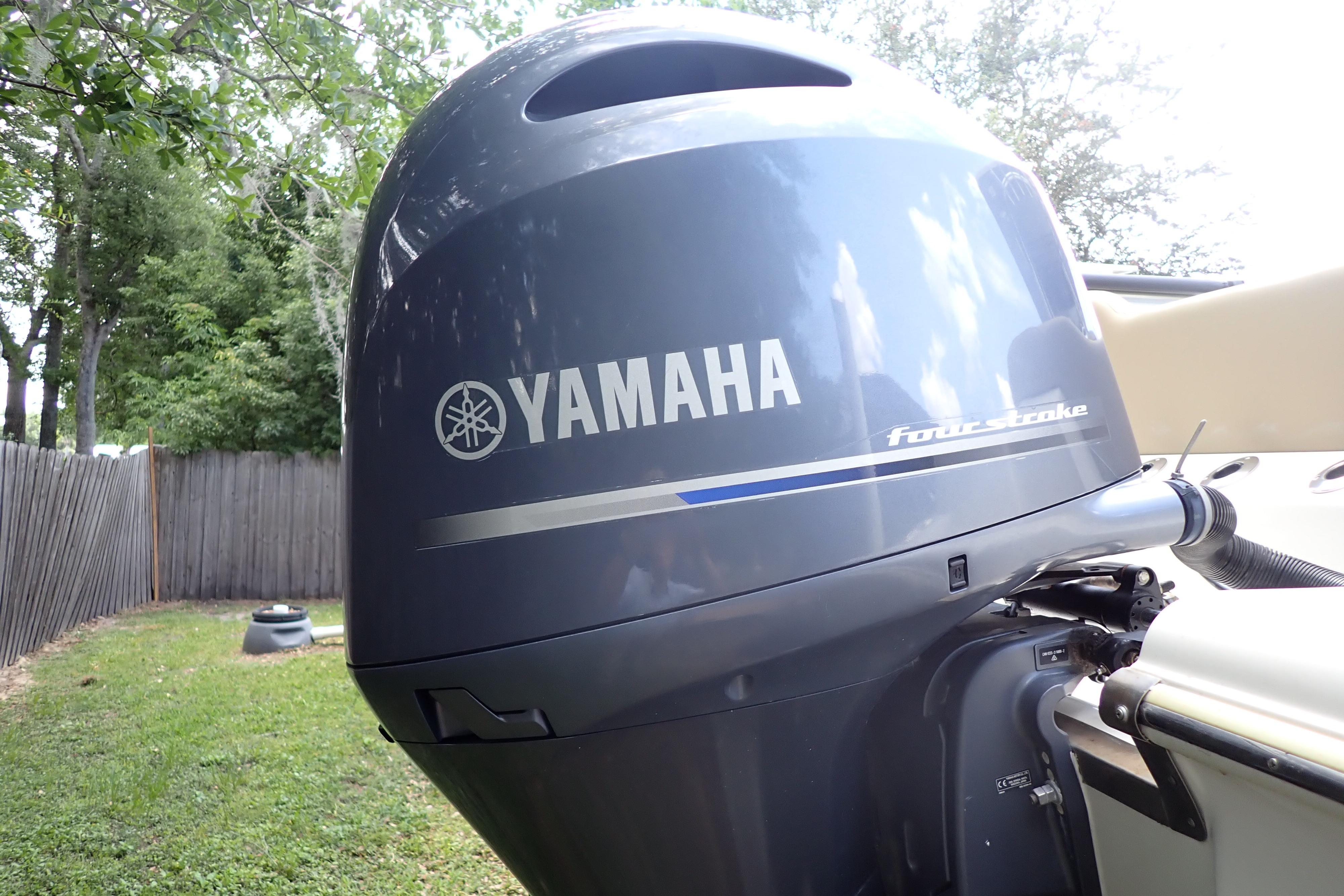 Yamaha four-stroke outboard motor on 2019 Key West 263 FS boat, outdoor setting.