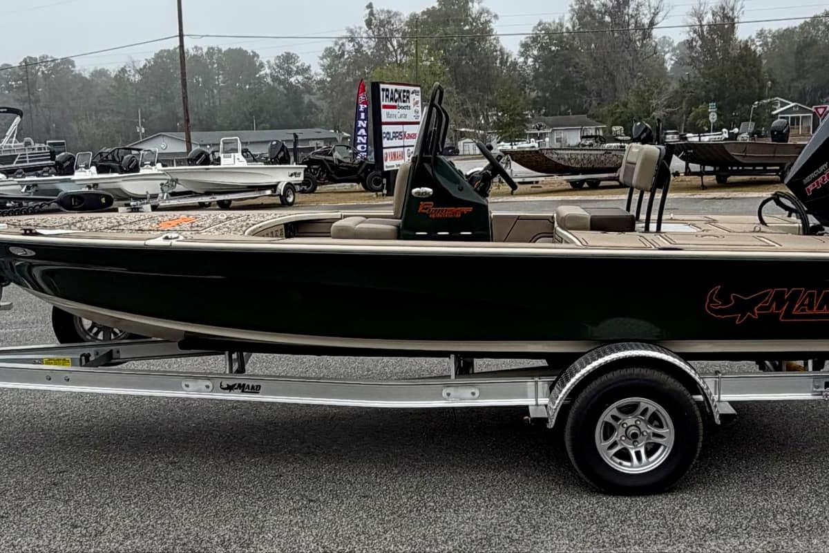 2025 Mako 18 Pro Skiff Backwater Edition boat on trailer, parked outdoors.