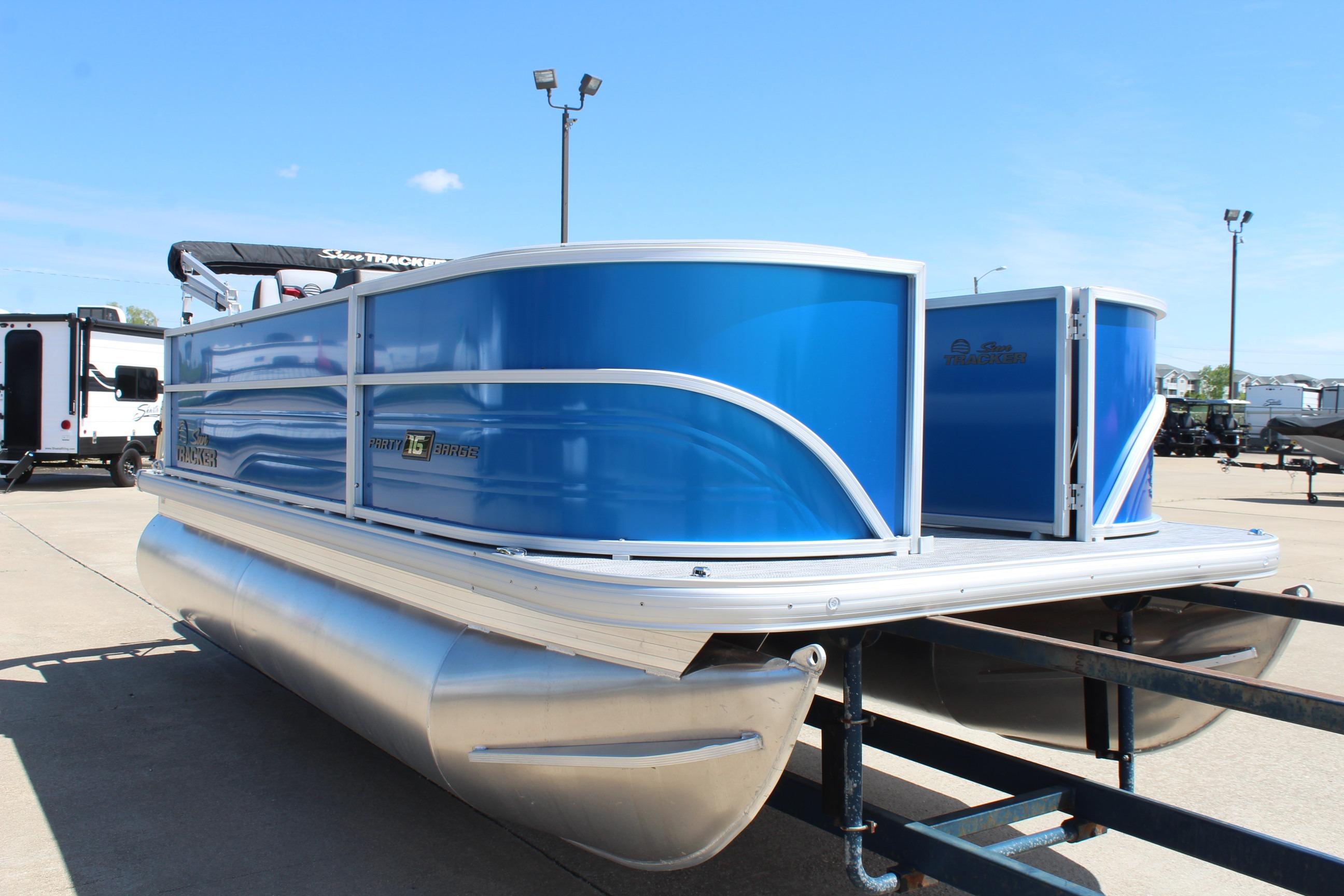 2026 Sun Tracker Party Barge 16 DLX pontoon boat in vibrant blue on trailer.