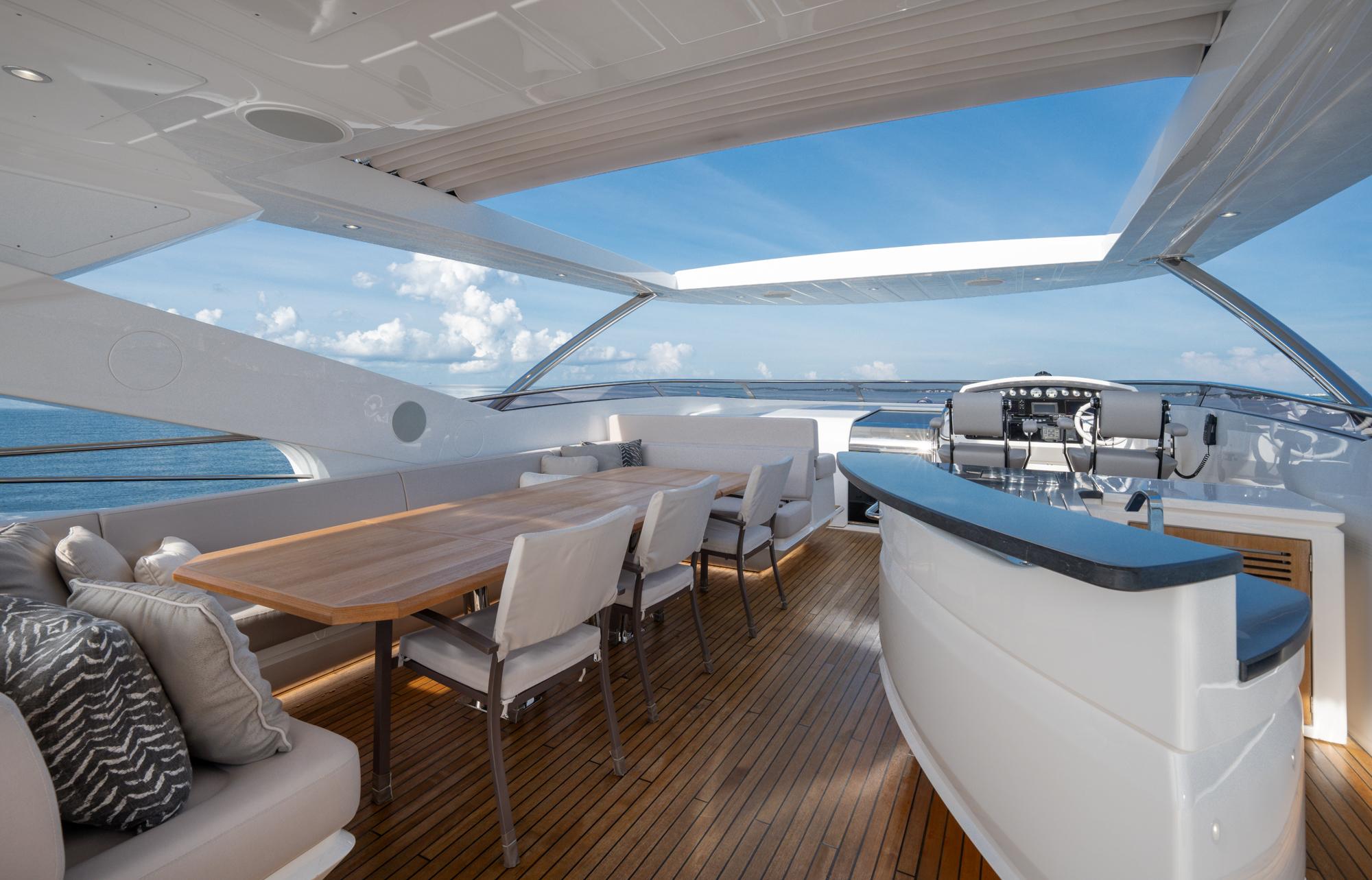 Luxurious 2021 Sunseeker 95 Yacht with spacious outdoor seating and dining area.
