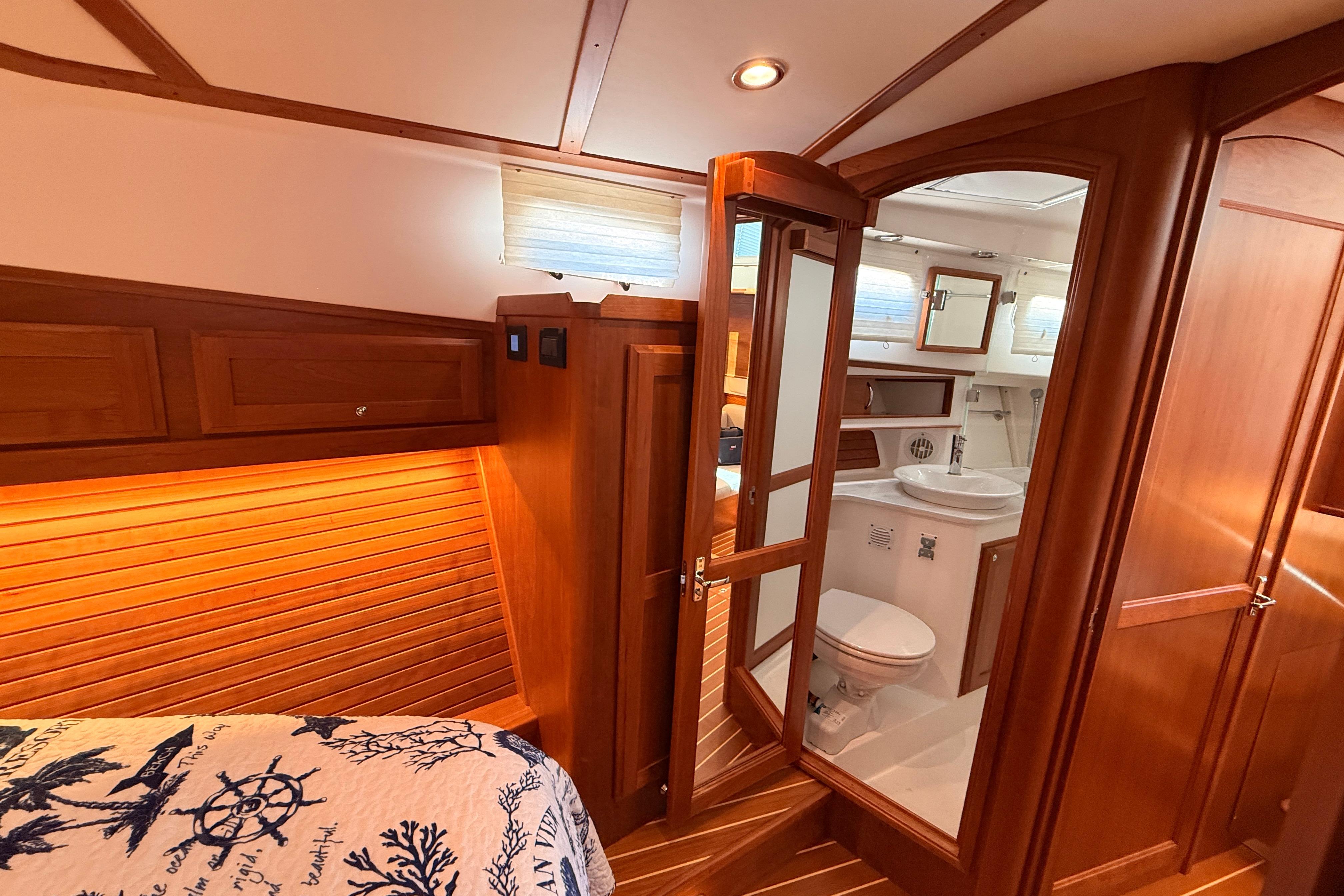 Luxurious 2022 Sabre 38 Salon Express interior with wooden finishes and modern bathroom.
