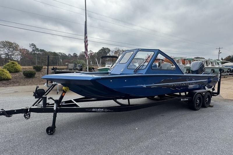 2026 SeaArk Dynasty 2.0 boat on trailer, blue exterior, parked outdoors.