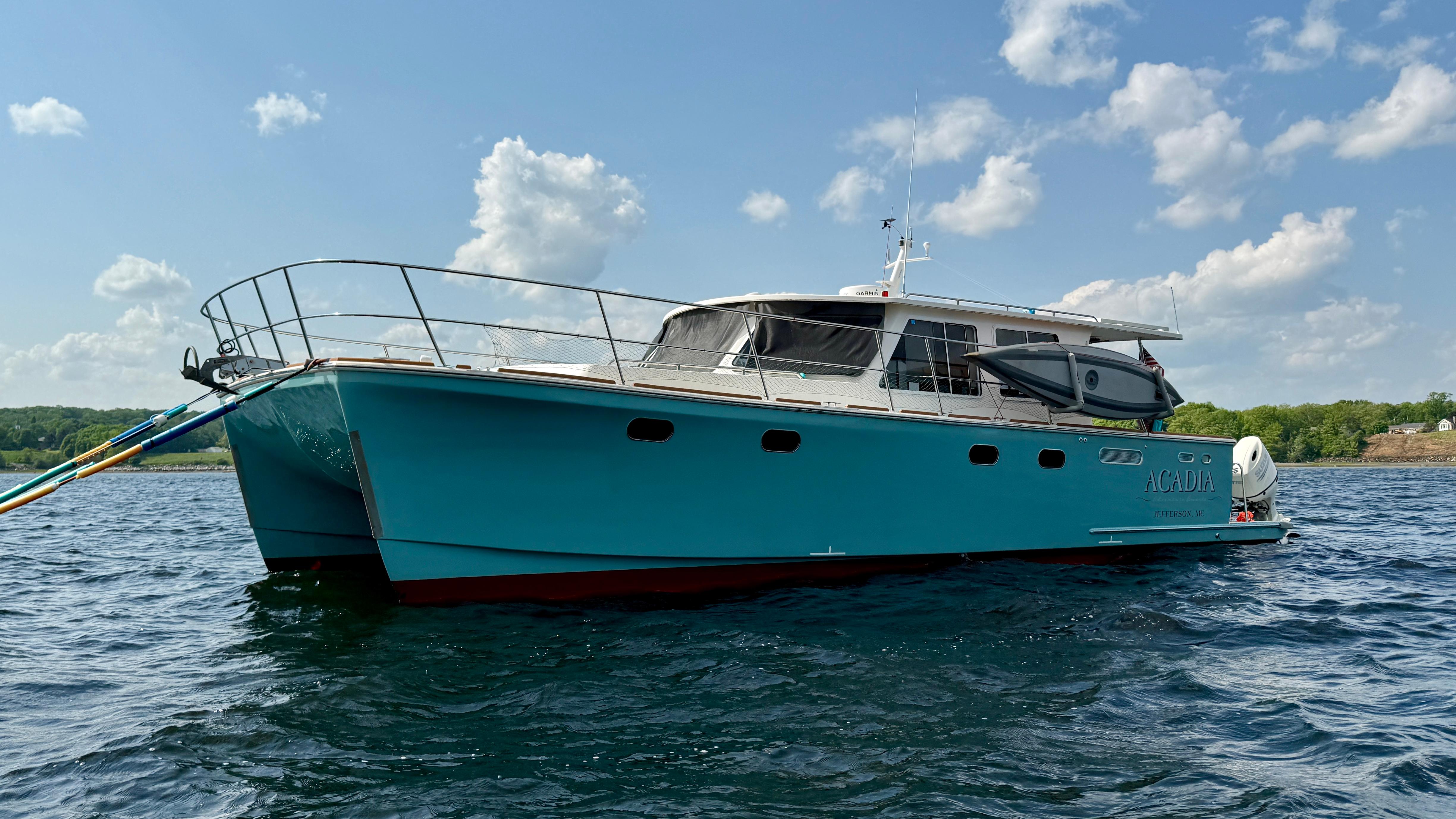 2014 Maine Cat P44 boat on water under blue sky.