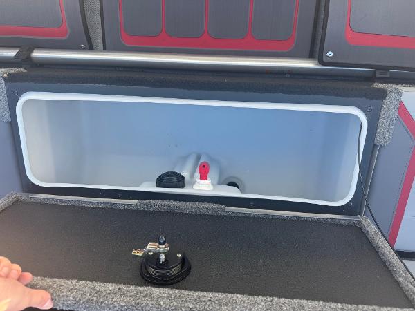 2025 Alumacraft Trophy 185X SC Rotax S storage compartment with latch and interior view.