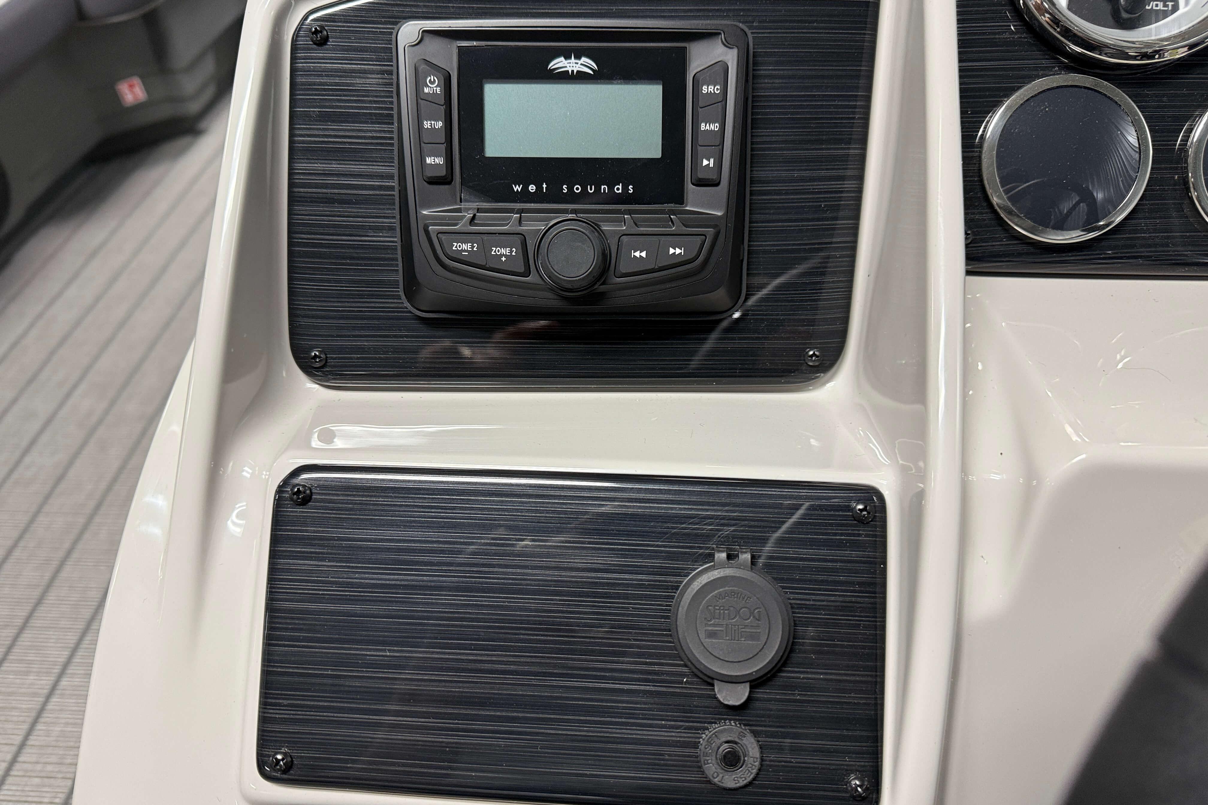 Control panel of 2026 Sylvan Mirage X1 boat with audio system and gauges.