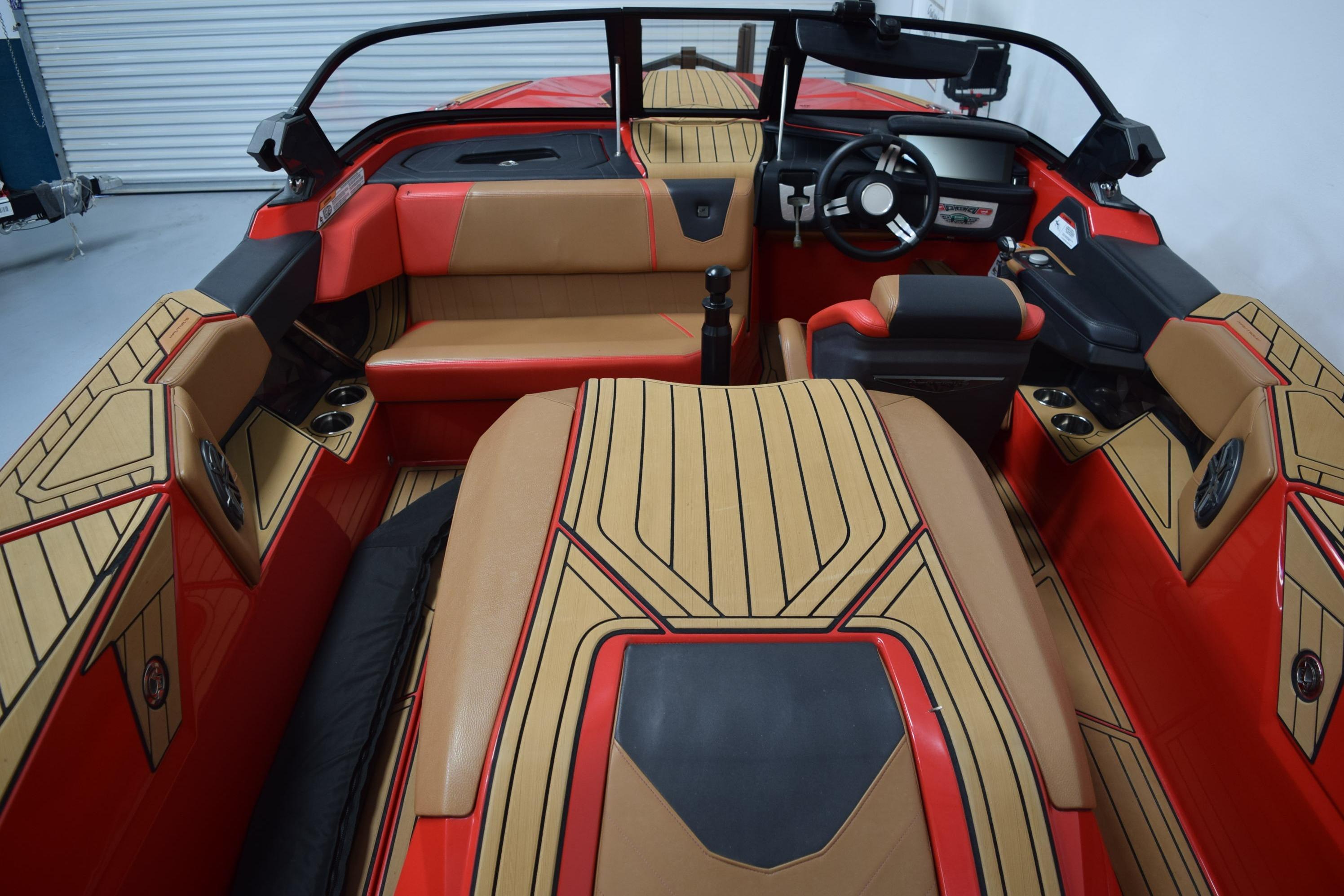2024 Nautique Ski Nautique interior with red and tan upholstery, sleek design, and modern dashboard.