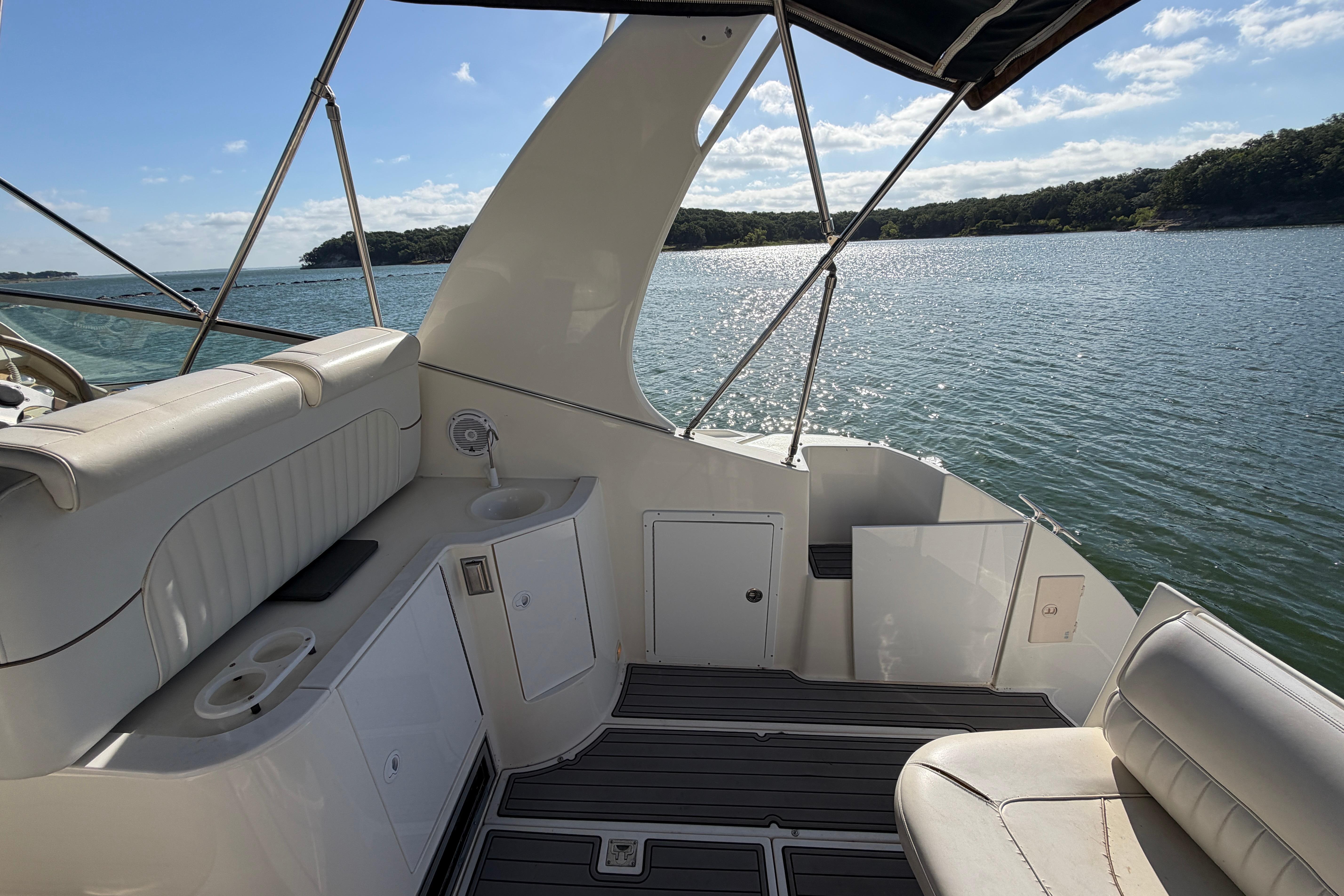 1997 Cruisers 3575 yacht interior with lake view and seating area.