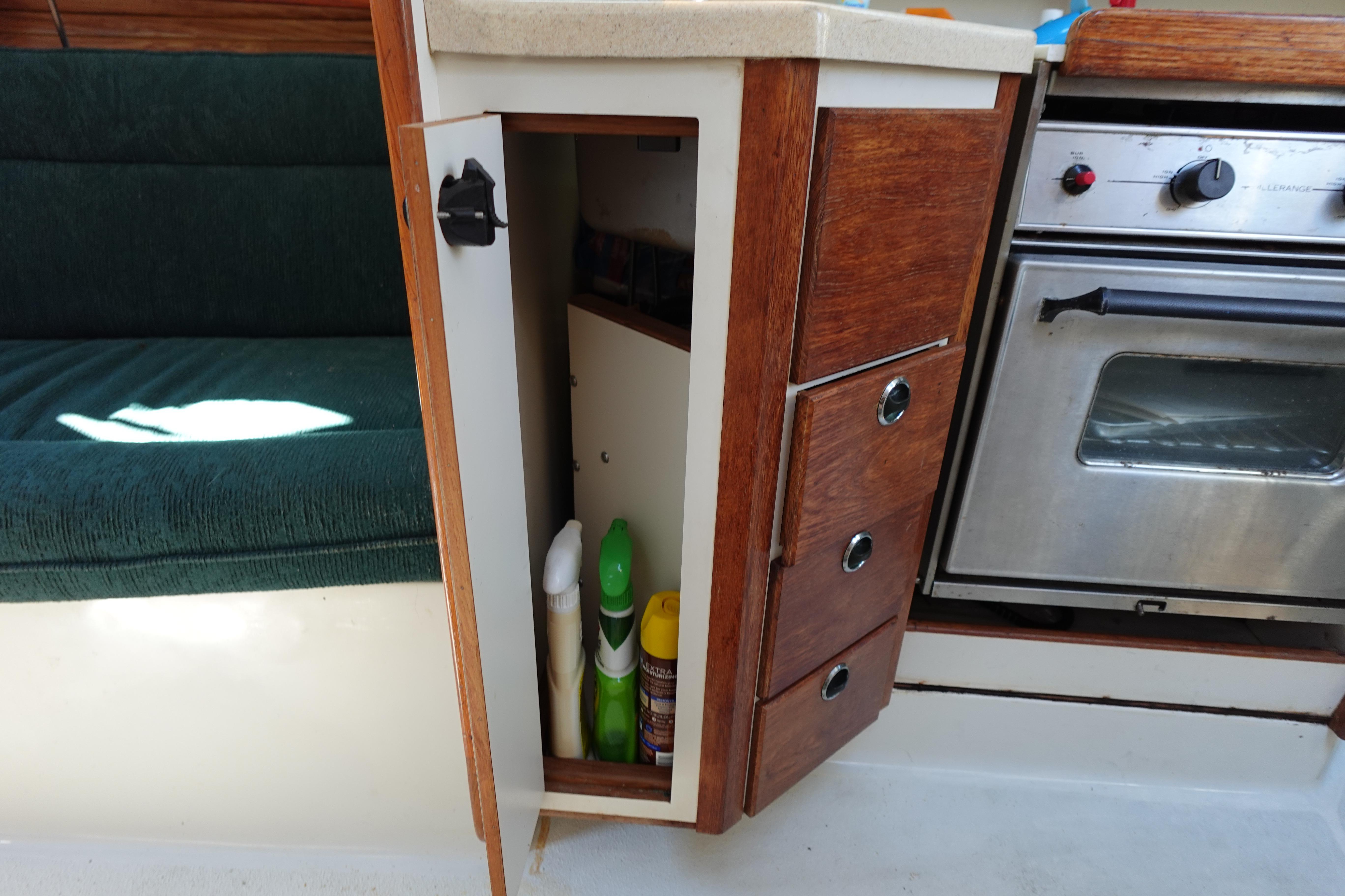 Interior of a 1997 Catalina 28 sailboat showing kitchen storage and oven.