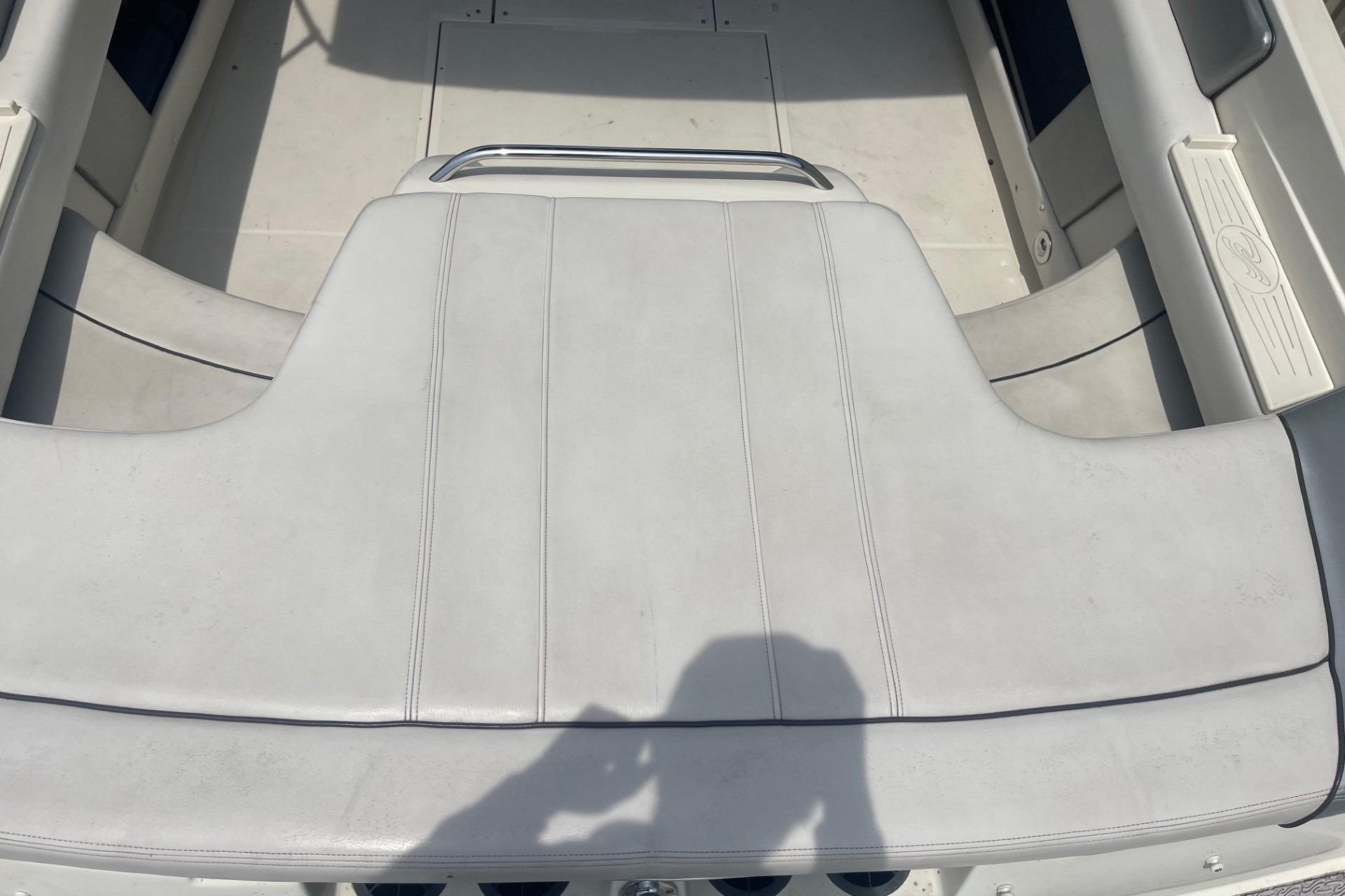 2010 Sea Ray 230 Bow Rider Select interior seating, featuring white upholstery and sleek design.