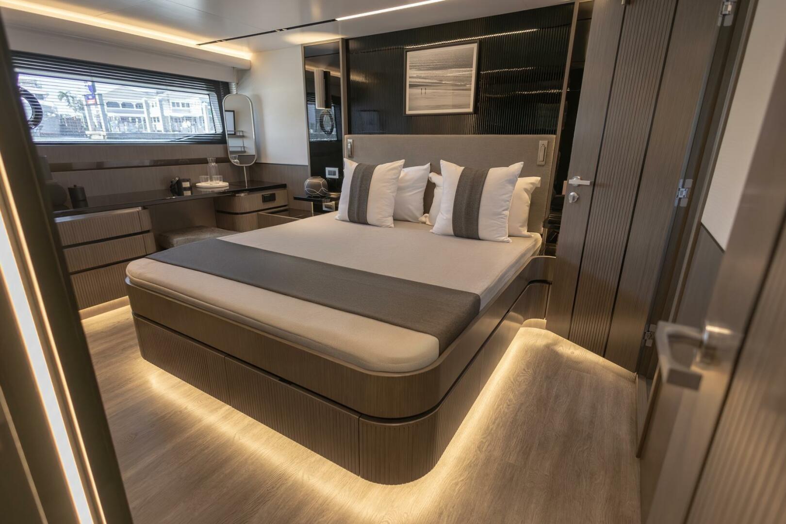 Luxurious bedroom interior on 2023 Pearl 72 yacht, featuring modern design and ambient lighting.
