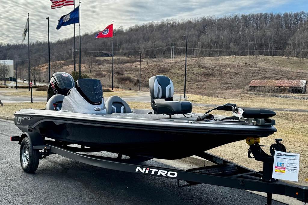 2026 Nitro Z17 boat on trailer, parked outdoors with flags in background.