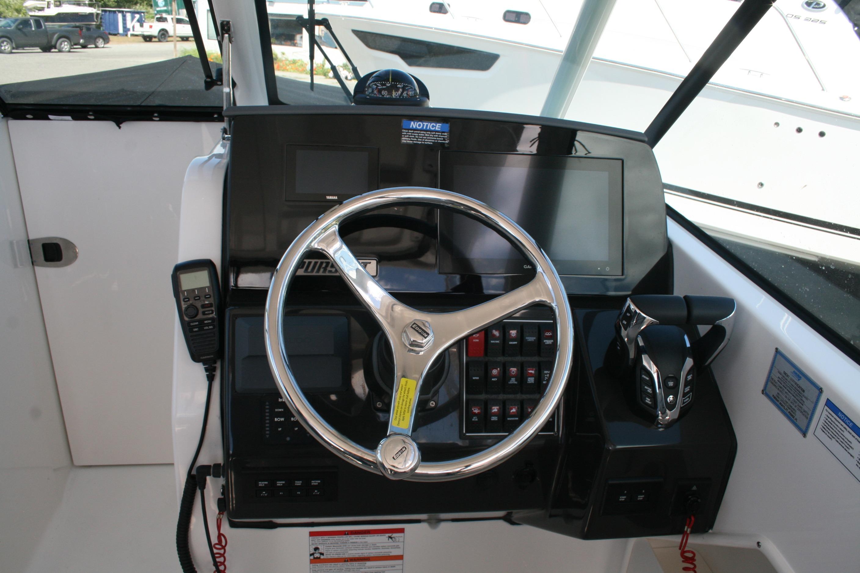 2026 Pursuit DC 266 Dual Console helm with steering wheel, controls, and display screens.