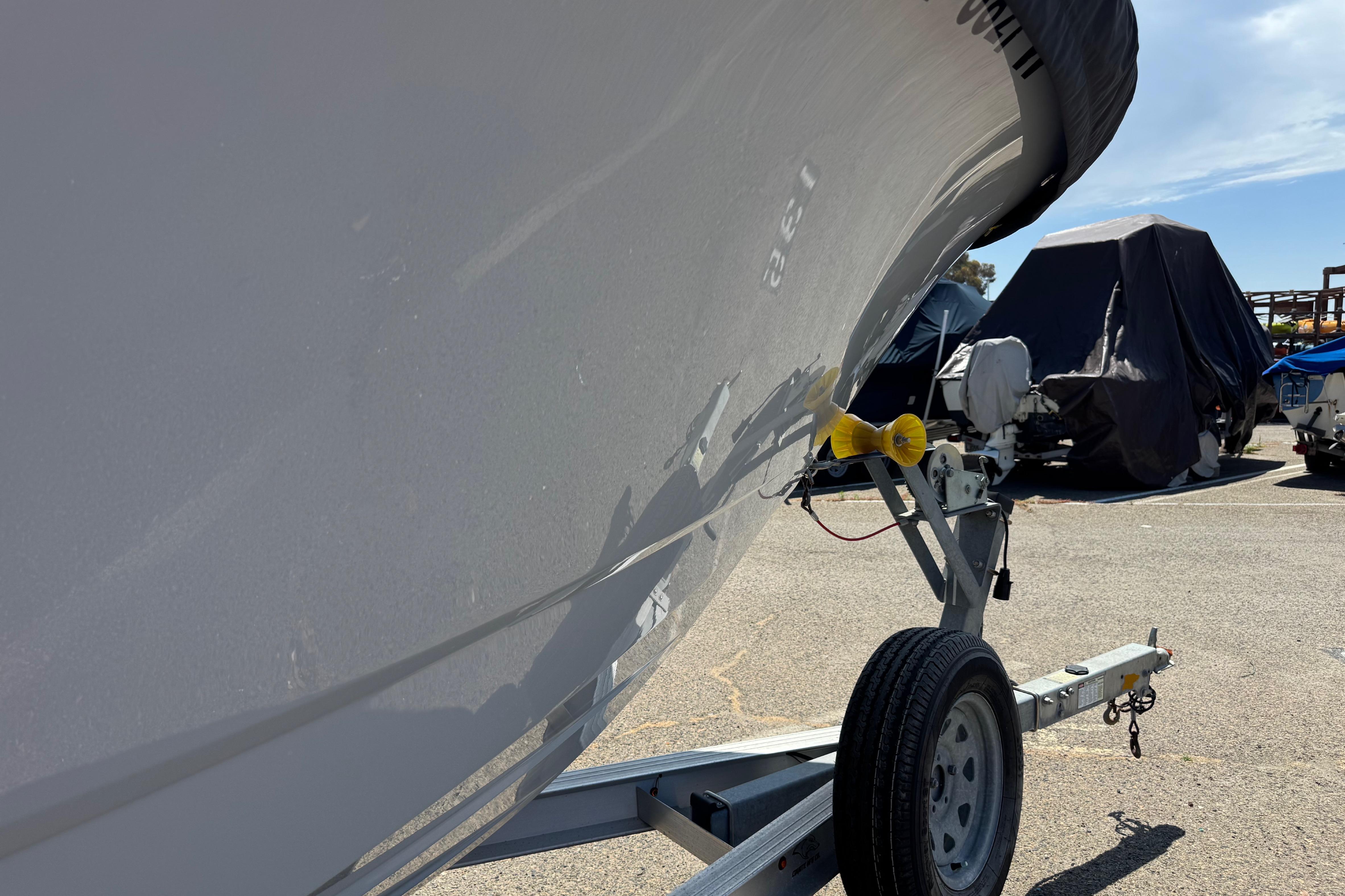2022 Robalo R230 Center Console boat on trailer in sunny parking lot.