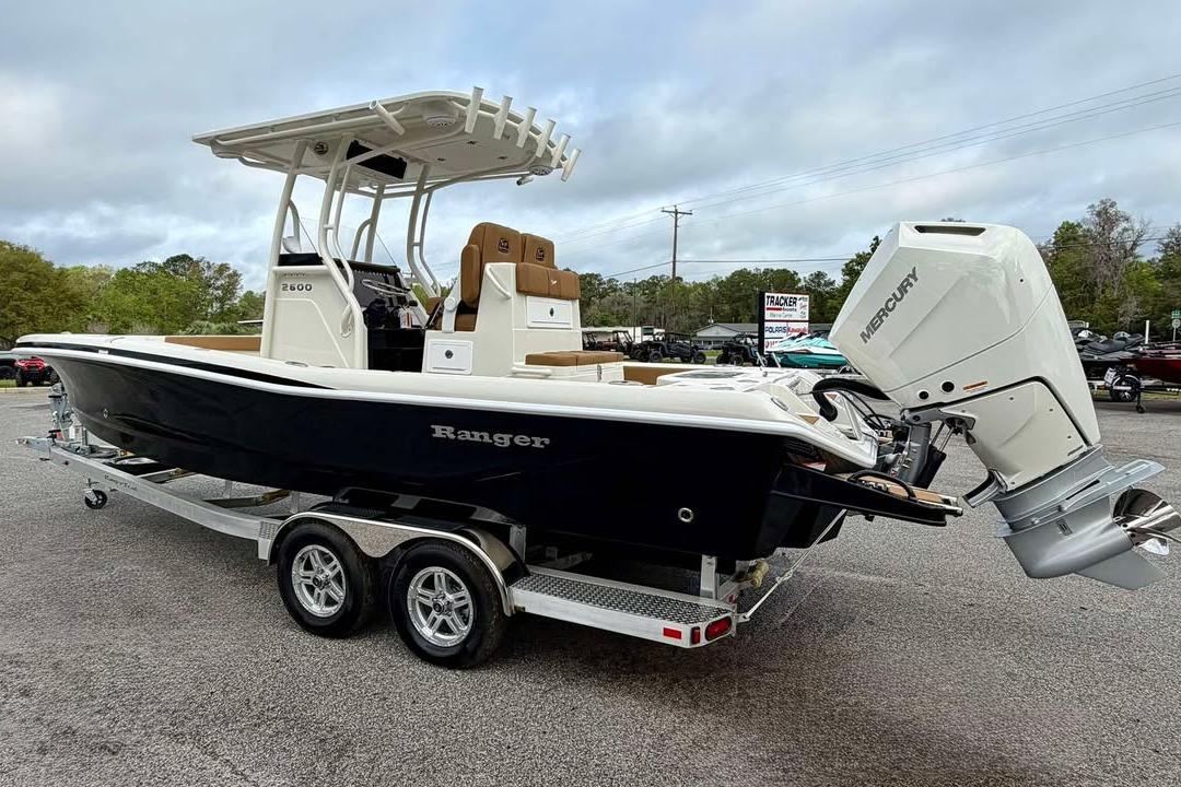 2026 Ranger 2600 Bay boat with Mercury engine on trailer, parked outdoors.