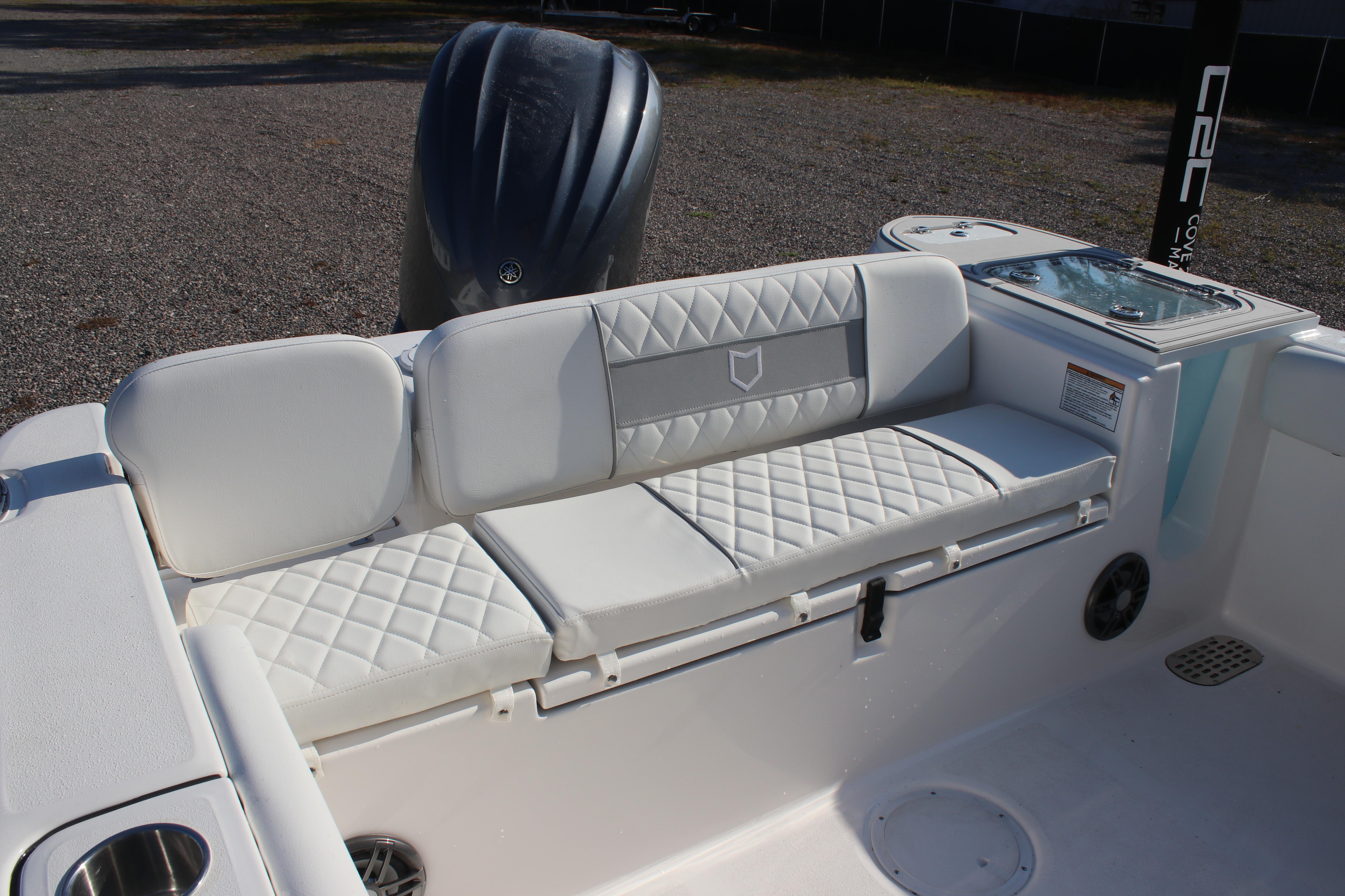 2026 Sea Fox 248 Commander boat interior with cushioned seating and storage.