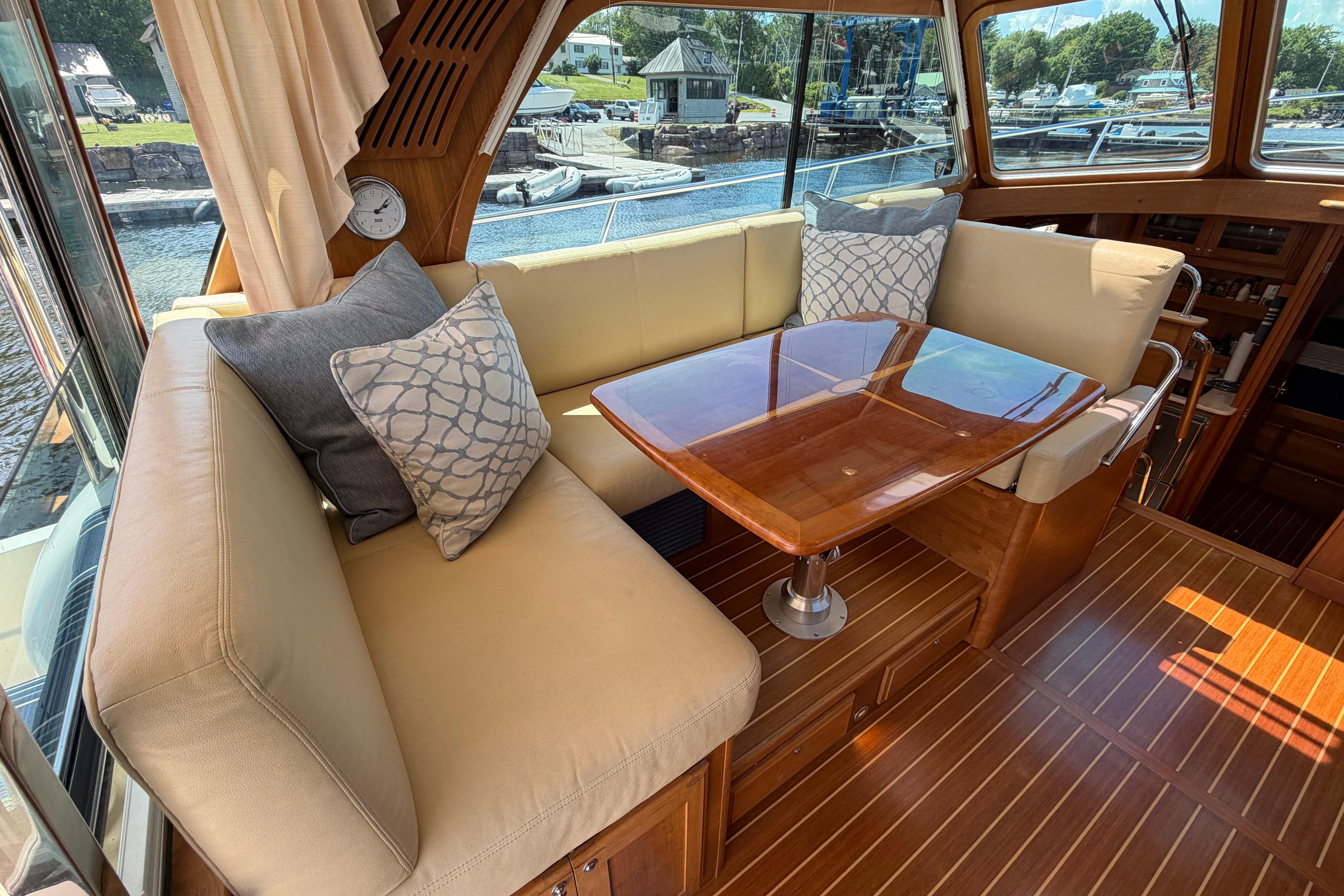 Luxurious interior of 2015 Sabre 38 Salon Express yacht with elegant seating and wooden table.